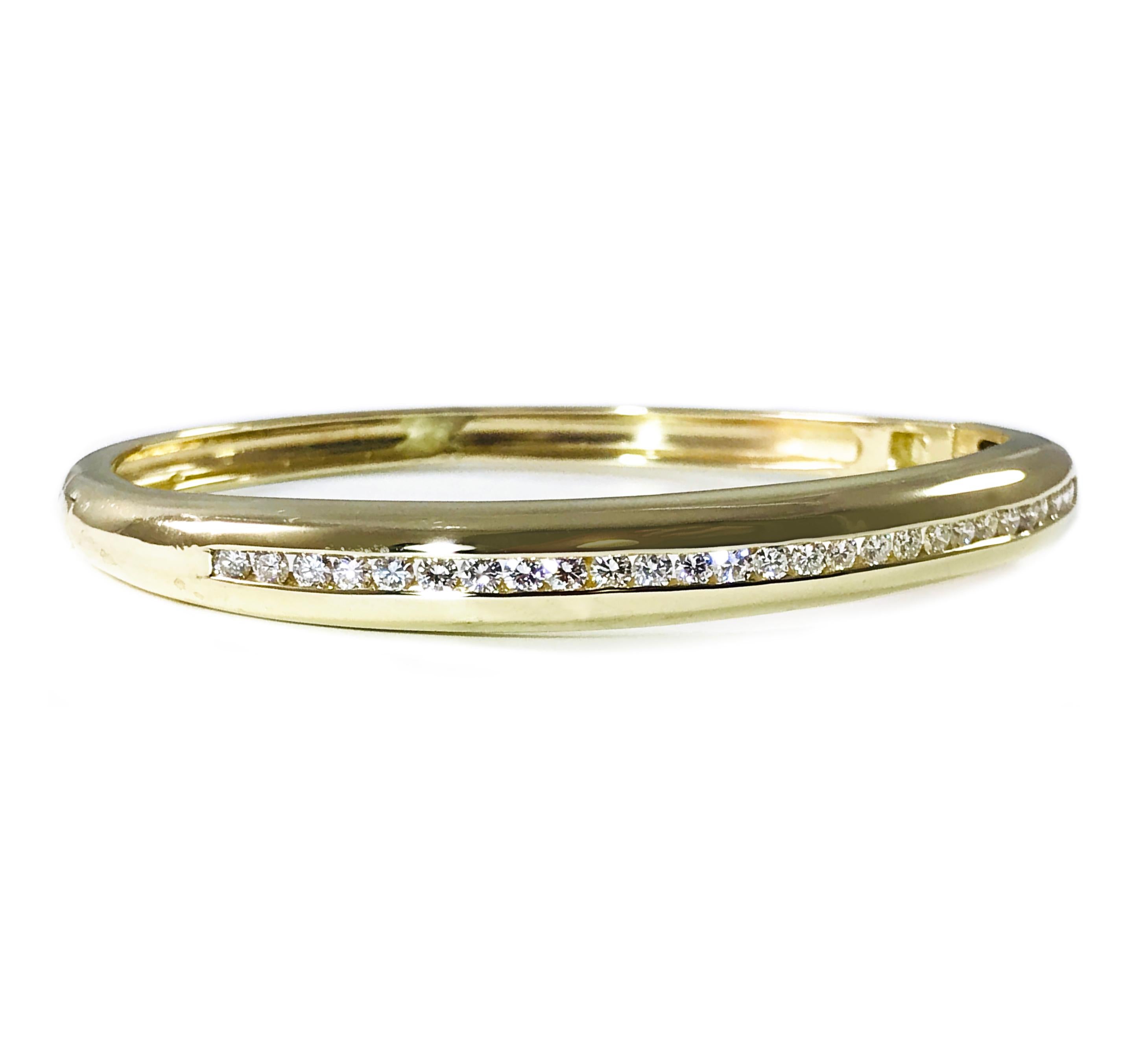 14 Karat yellow gold Diamond Bangle Bracelet. Twenty-seven Russian brilliant-cut round diamonds are channel-set in this lovely hinged bangle bracelet. Diamonds are SI1-SI2 in clarity (G.I.A.) and H-I in color (G.I.A.) for a total weight of 1.20ctw.