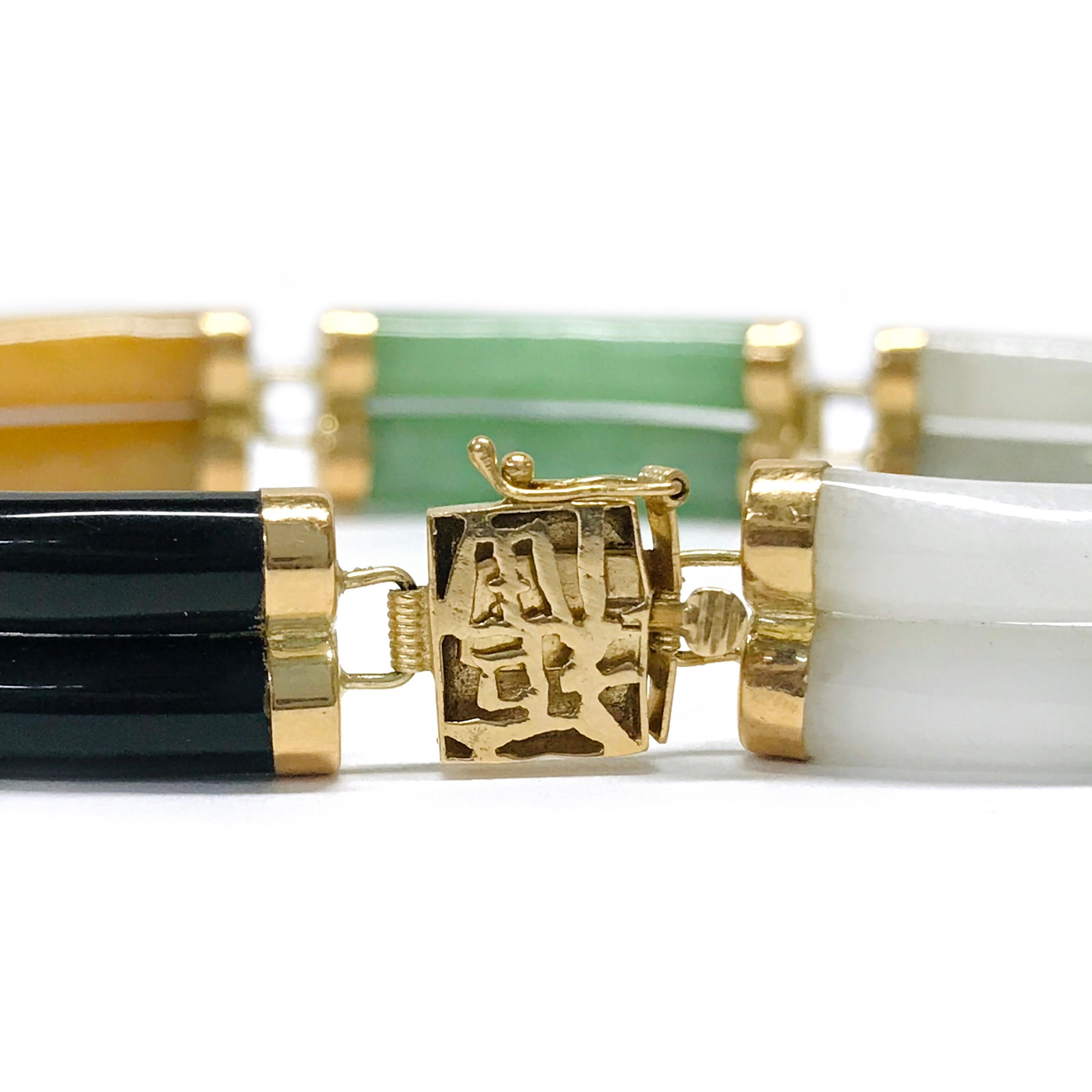 Beautiful double link Jade station bracelet in 14k gold. The bracelet features double links of white, red, green, yellow, light green, and black Jade for a total of fourteen links, each capped in 14k gold and linked with a hinge. The links are