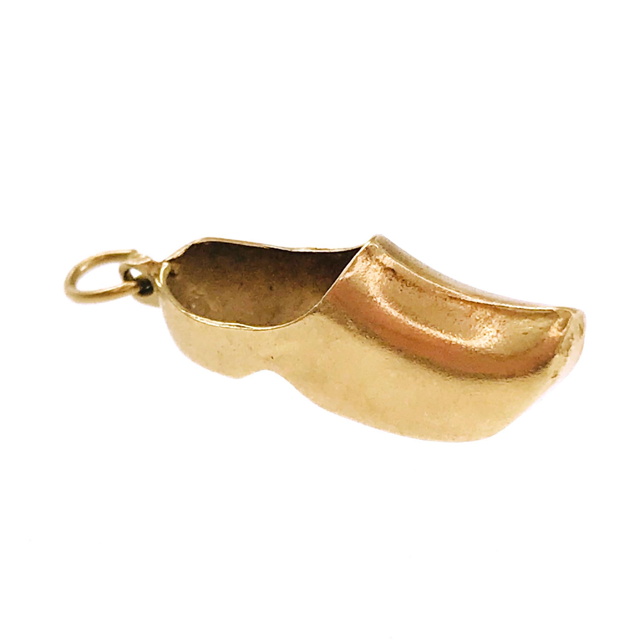 14 Karat Danish Clog Shoe Pendant. The pendant has an overall smooth finish and measures 9.6mm tall x 7.0mm wide x 26.8mm long. The total weight of this traditional vintage pendant/charm is 3.6 grams.