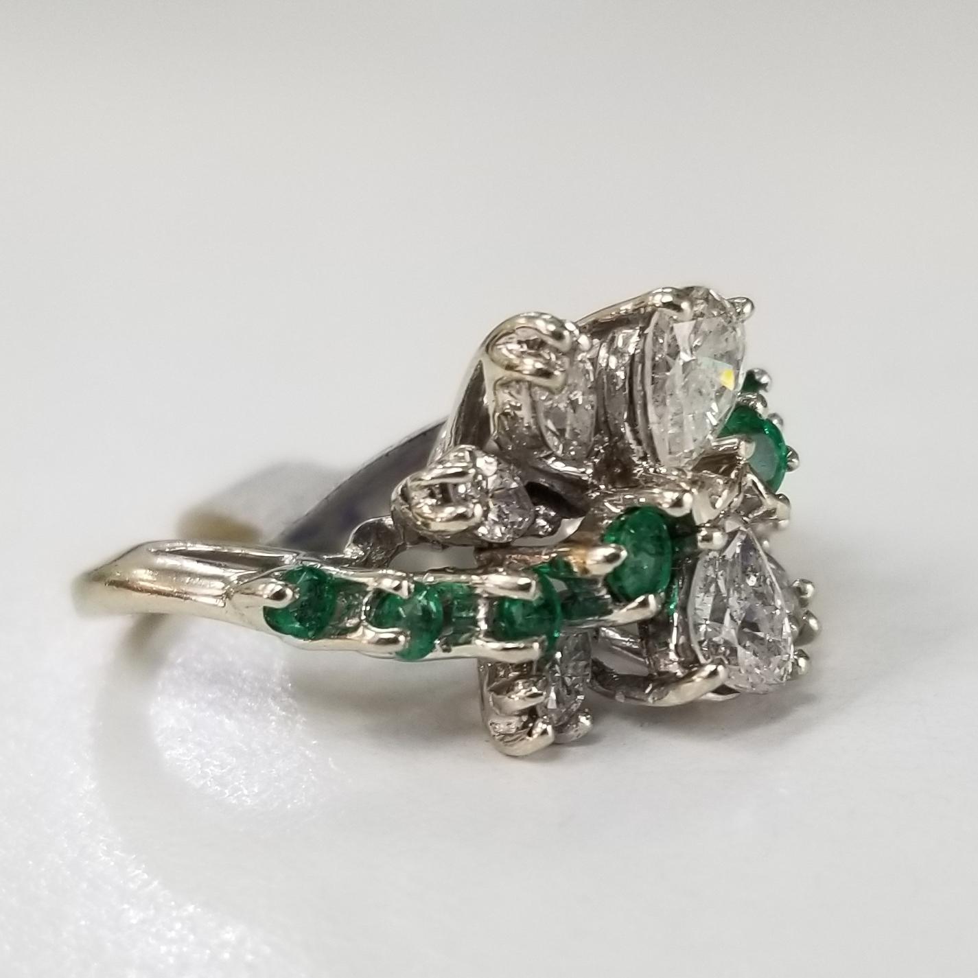 14 karat Diamond and Emerald cocktail ring, containing 2 pear shape cut, 4 marquise cut diamonds of very fine quality weighing2.08cts. and 8 round emeralds weighing .45pts.