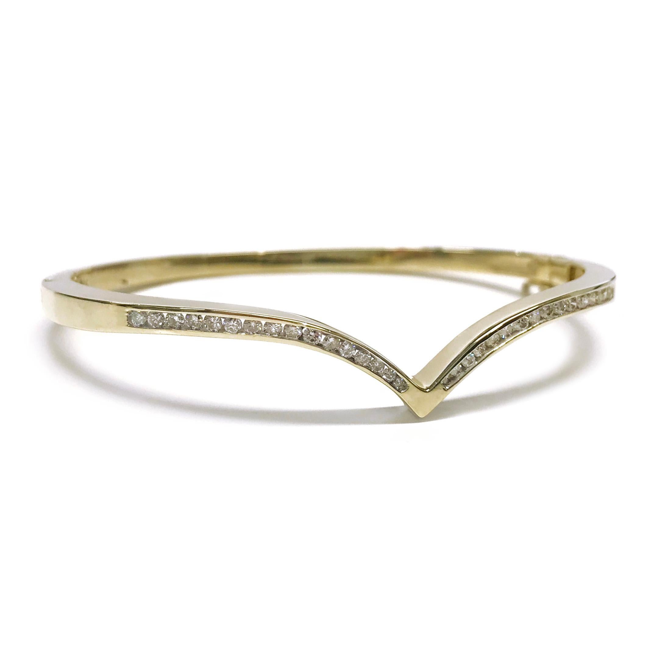 14 Karat Curved Channel-Set Diamond Hinged Bangle Bracelet. Thirty-two round diamonds are channel-set on the top of this delicately designed hinged bangle bracelet. The sides of the bracelet come together to form a peak at the center. Diamonds are