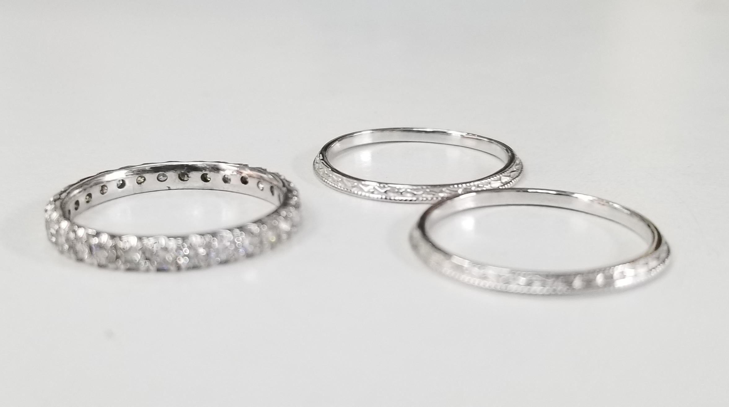 14k white gold diamond eternity ring with 28 round full cut diamonds of very fine quality weighing .70pts. with 2 14k white gold hand engraved beveled rings.  3 separate rings to mix and match. size 6