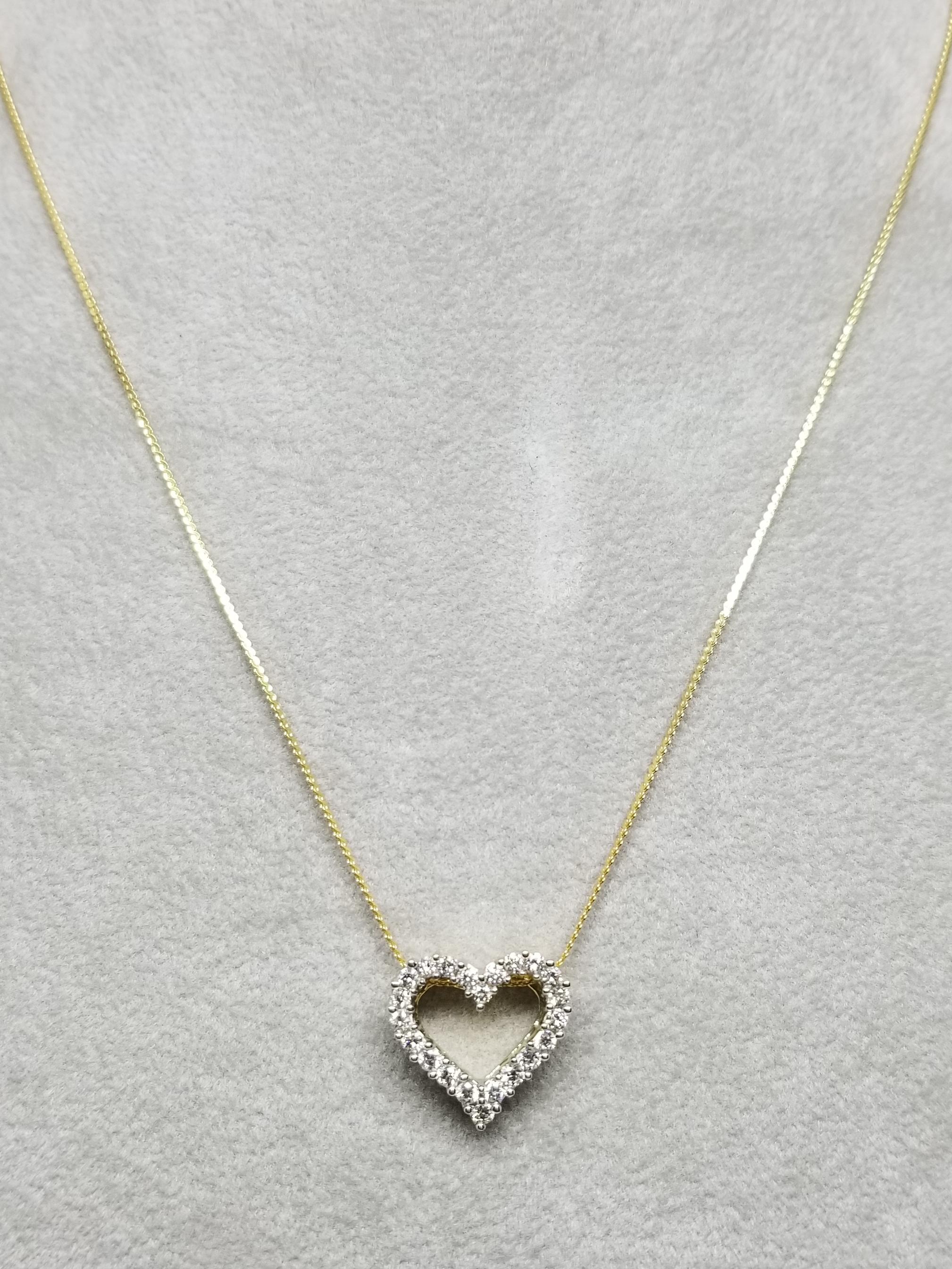 14 karat diamond heart necklace, containing 22 round full cut diamonds of very fine quality weighing .66pts.