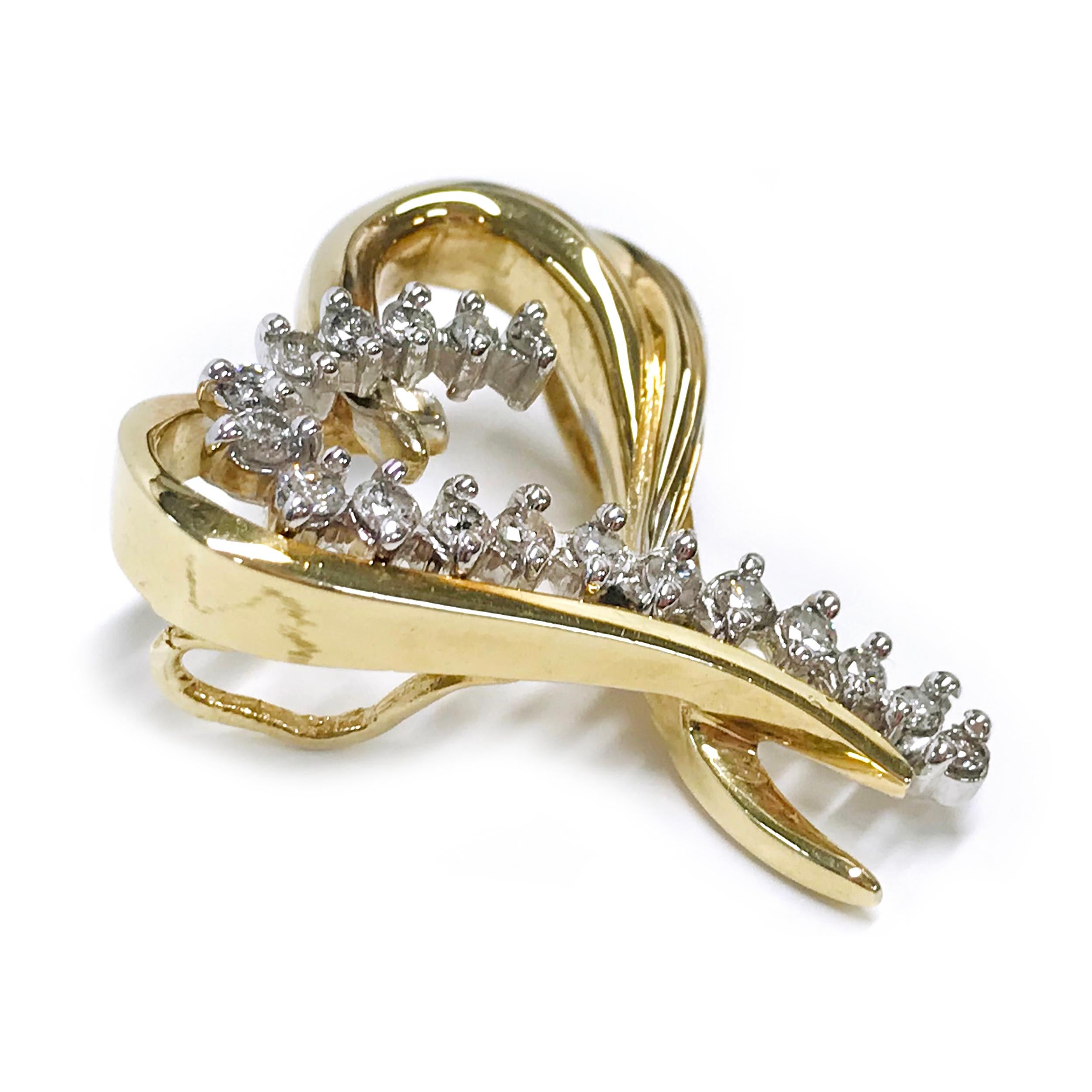 14 Karat yellow and white gold Diamond Heart Slide Pendant. The heart-shaped pendant features gold swooshes that create a heart and along with one of the gold, swooshes are eighteen round diamonds, all prong-set in white gold. The pendant measures