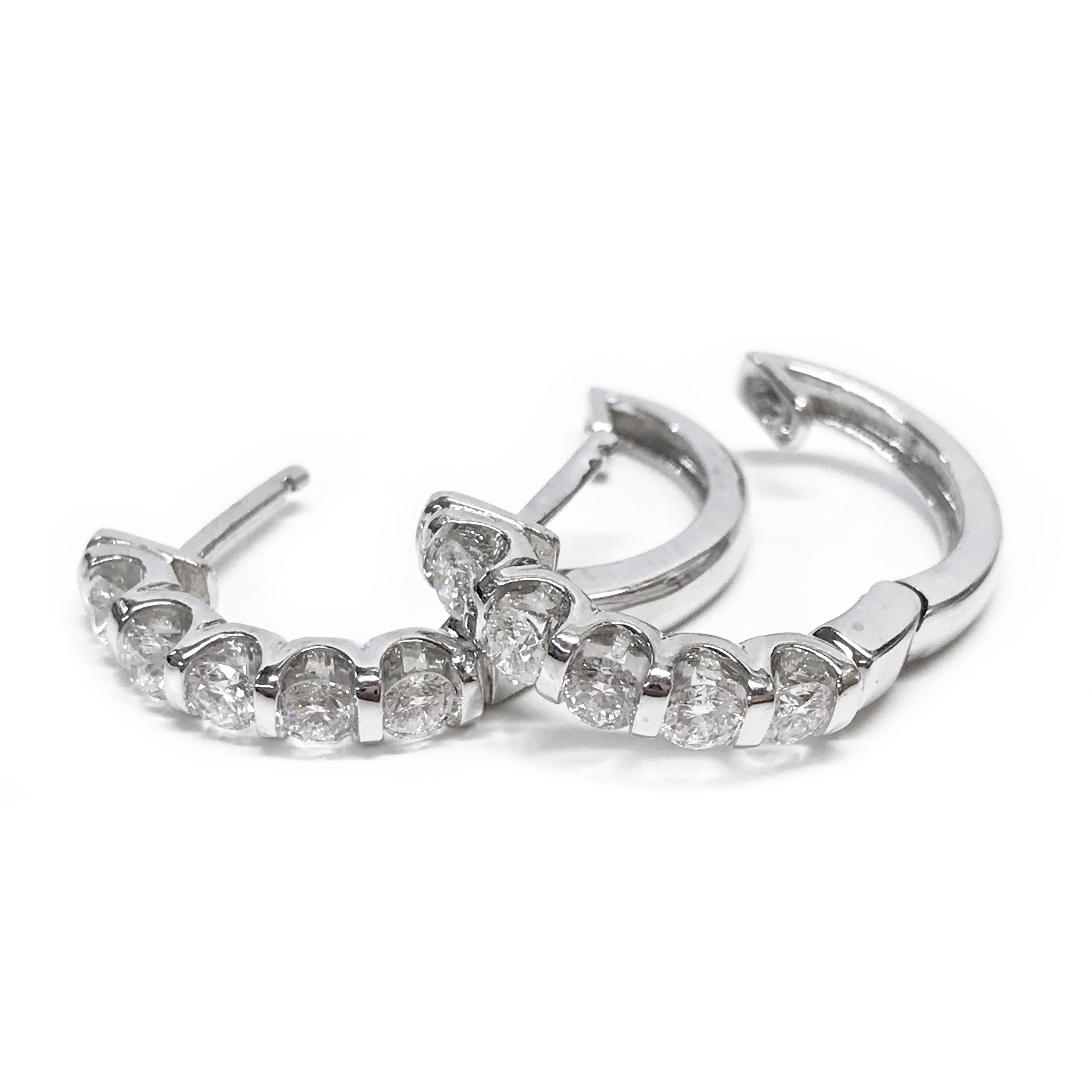 14 Karat White Gold Diamond Hoop Earrings. The petite earrings feature five 3mm bar-set round diamonds on each earring. The diamonds are SI1-SI2 (G.I.A.) in clarity and G-H (G.I.A.) in color. The total carat weight of the ten diamonds is 1.00tcw.