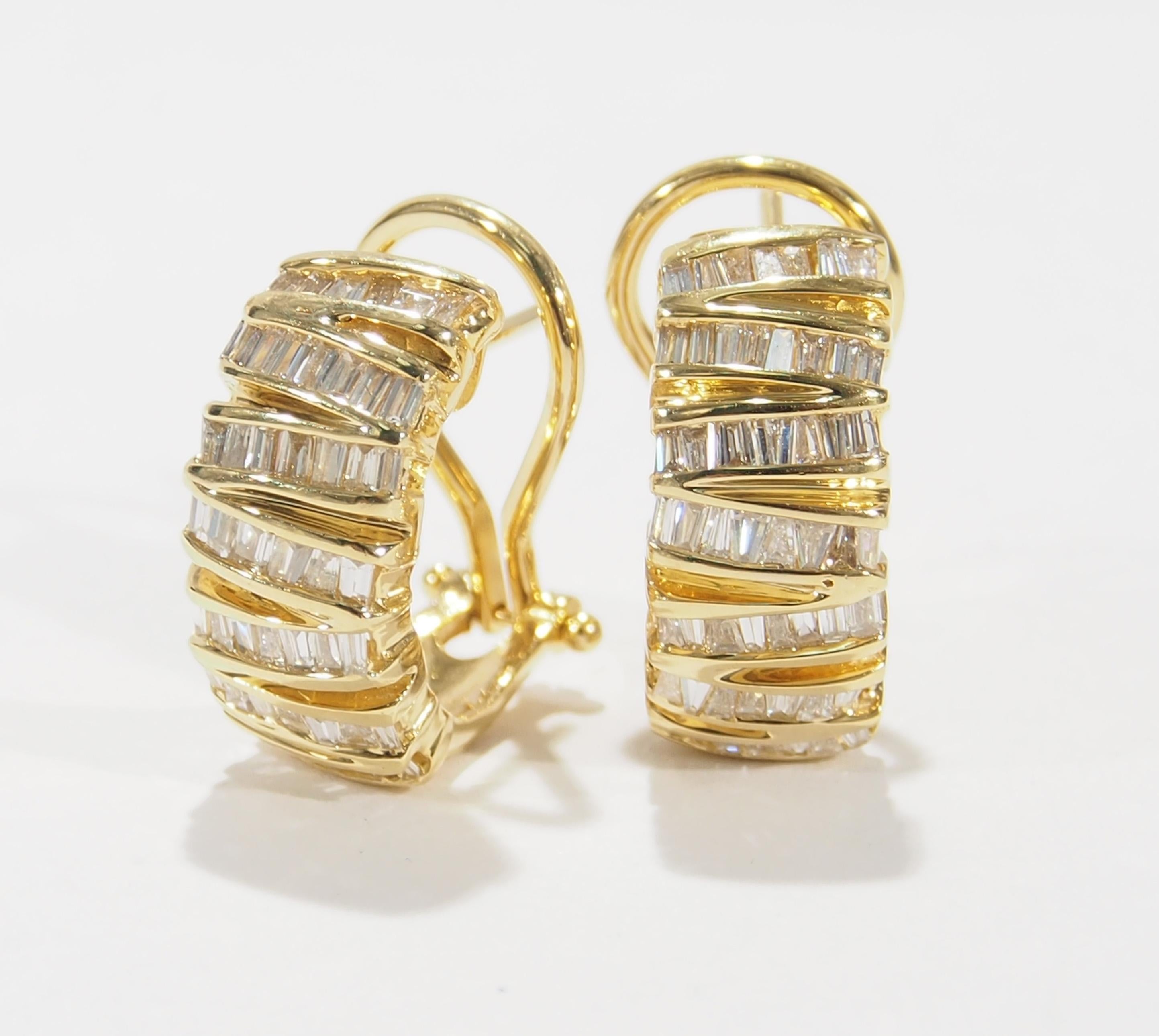 These are a stunning pair of 14K Yellow Gold and Diamond Huggie Style Earrings. The Earrings are 3/4 inch in length and 1/4 inch in width with (94) Baguette Diamonds, approximately 1.88ctw, G-H in Color, VS-SI in Clarity set artistically between