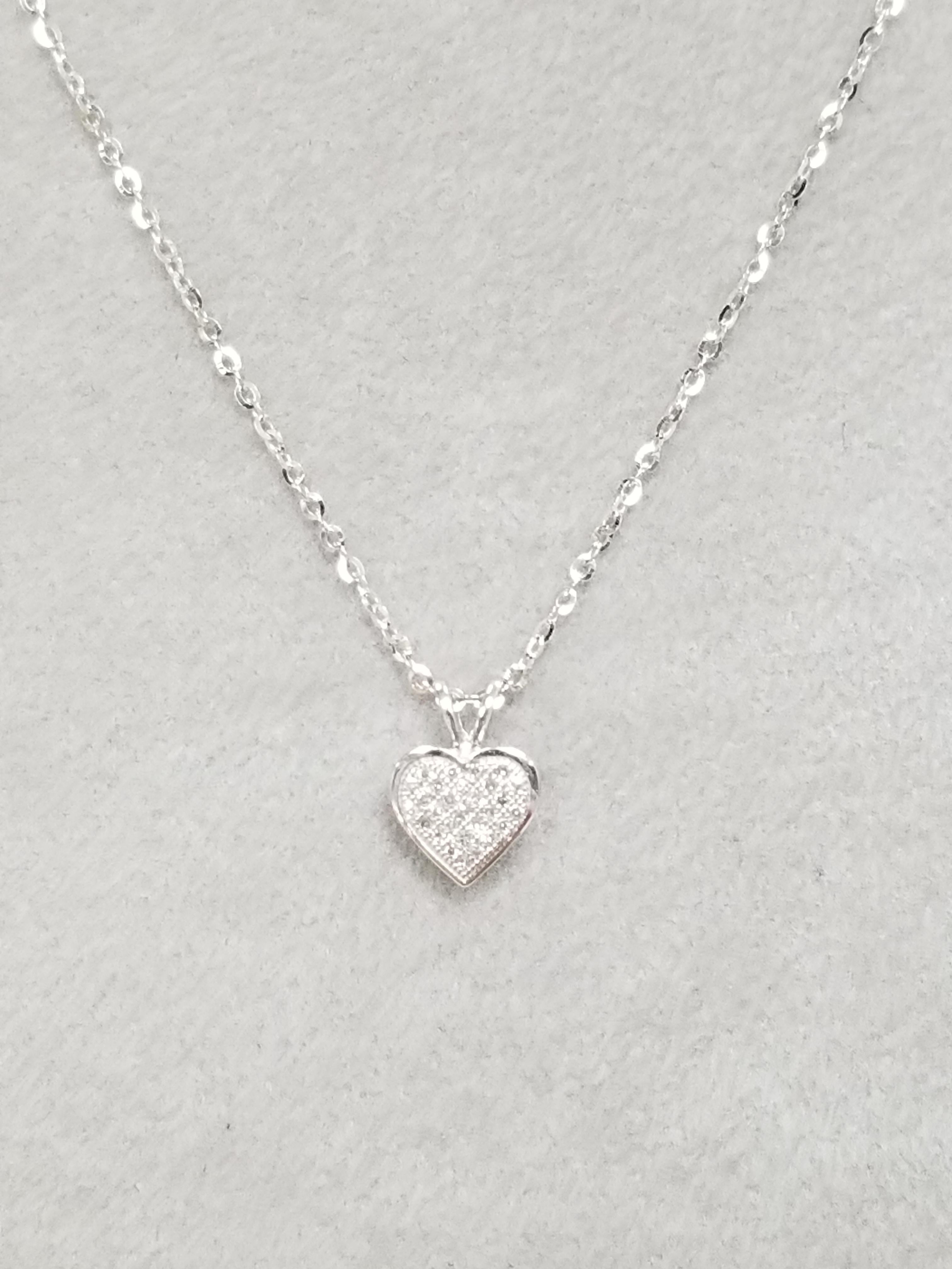 14k Diamond Pave' Heart containing 28 single cut diamonds of very fine quality weighing .15pts. on a 16 inch chain.
