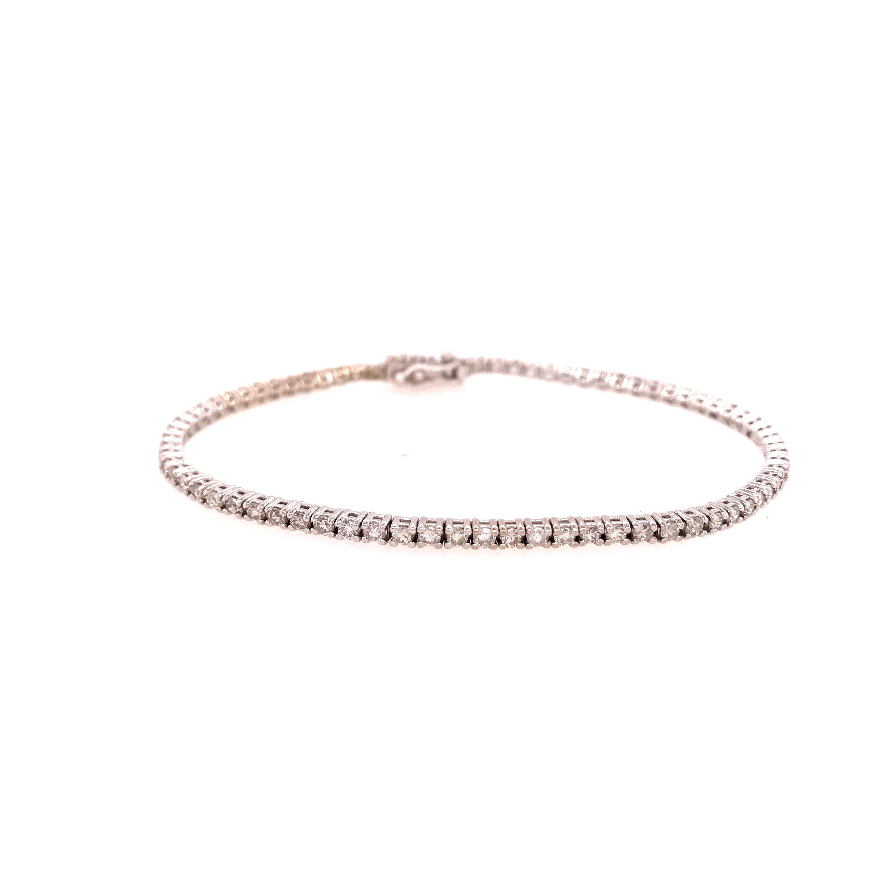 A beautiful classic Diamond Tennis Bracelet in 14K White Gold.  (76) Round Brilliant Cut Diamonds 1.52 carat total weight, G-H in color, VS-SI in clarity are expertly set in this bracelet.  6 3/4 inches long, approximately 2/8 inch wide and weighs