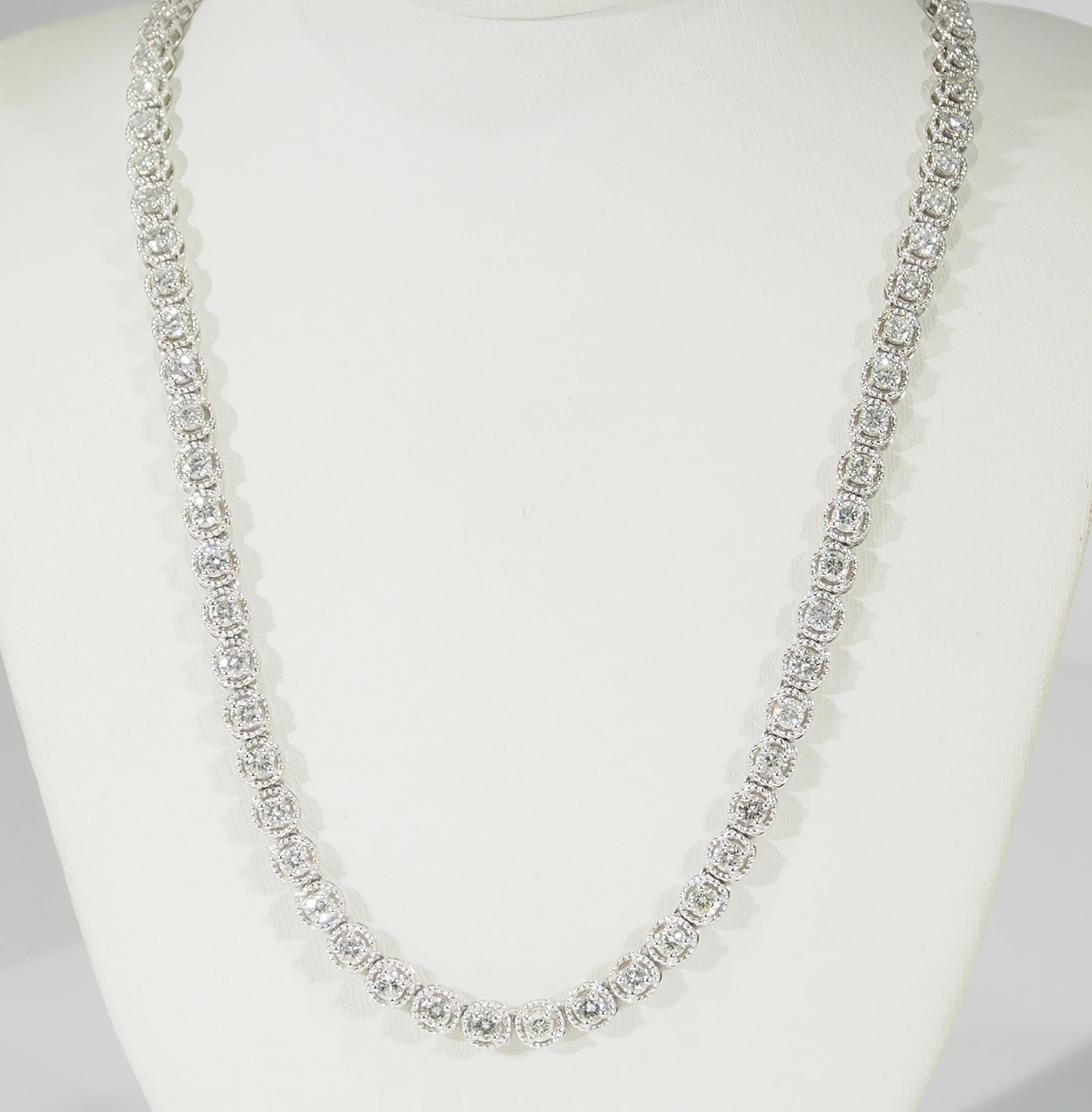 This is a lustrous 14K White Gold Tennis Necklace designed with Rope-Like settings encircling the (88) Round Brilliant Cut Diamonds, approximately 7.09ctw, G-H in Color, VS-SI3 in Clarity allowing this Necklace to Sparkle in a 17 inch length. An