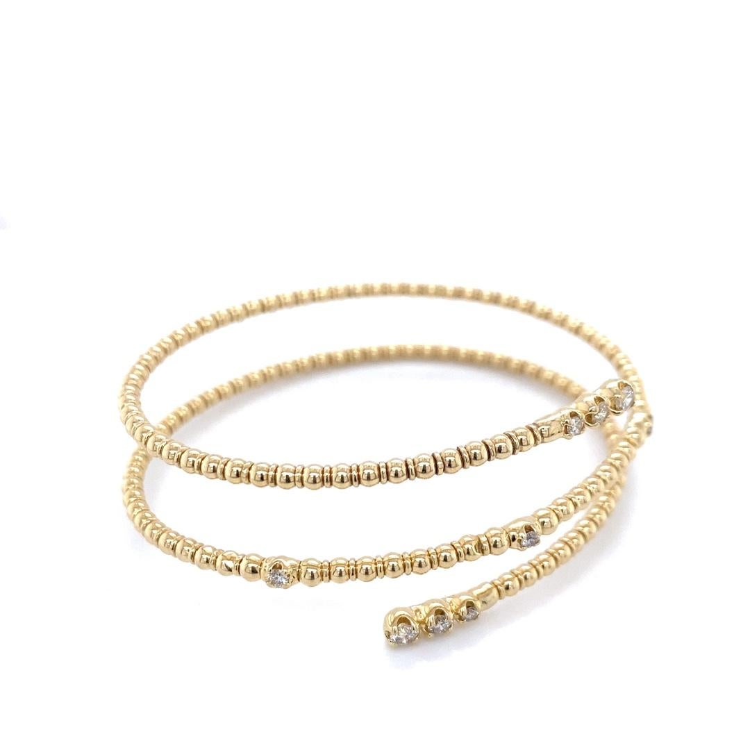 Dieses wunderschöne Armband ist aus 14 Karat Gold gefertigt und hat ein Gesamtgewicht von 0,50cttw Diamanten. Die Wickelform verleiht dem Armband einen stapelbaren Look. Es ist mit einer Perlenstruktur entlang des Umschlags versehen. Dieses Stück
