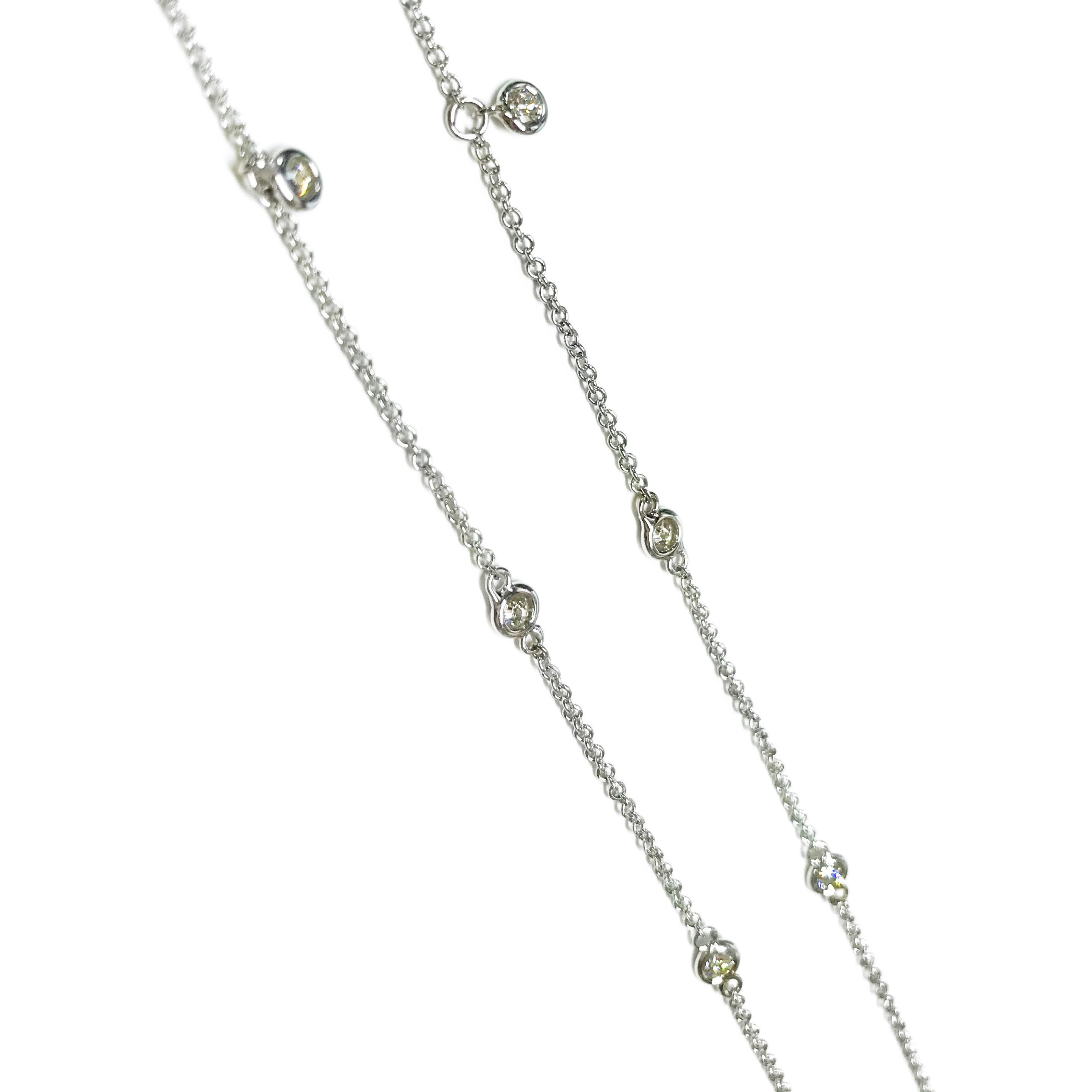 14 Karat White Gold Diamonds By The Inch Necklace. Thirteen exquisite 2.2mm diamonds are showcased in circle stations all in white gold. Diamonds are SI-SI2 (G.I.A.) in clarity and G-H (G.I.A.) in color for a total weight of 0.61ctw. The lower seven