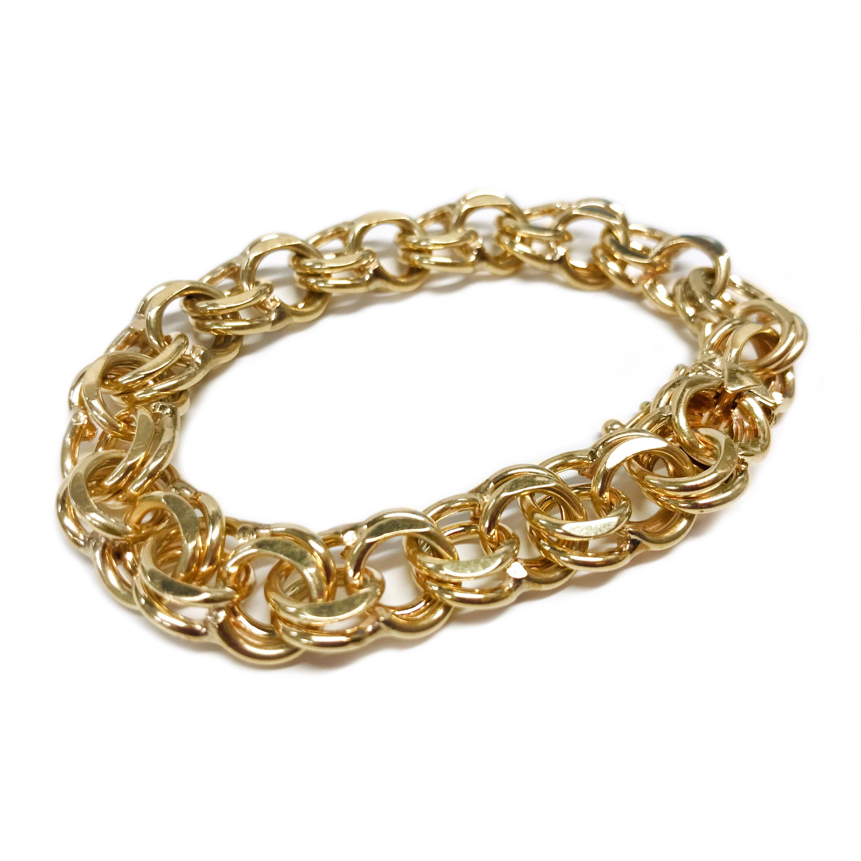 14 Karat Wide Double Link Charm Bracelet. The bracelet features yellow gold double links. The bracelet is 0.40