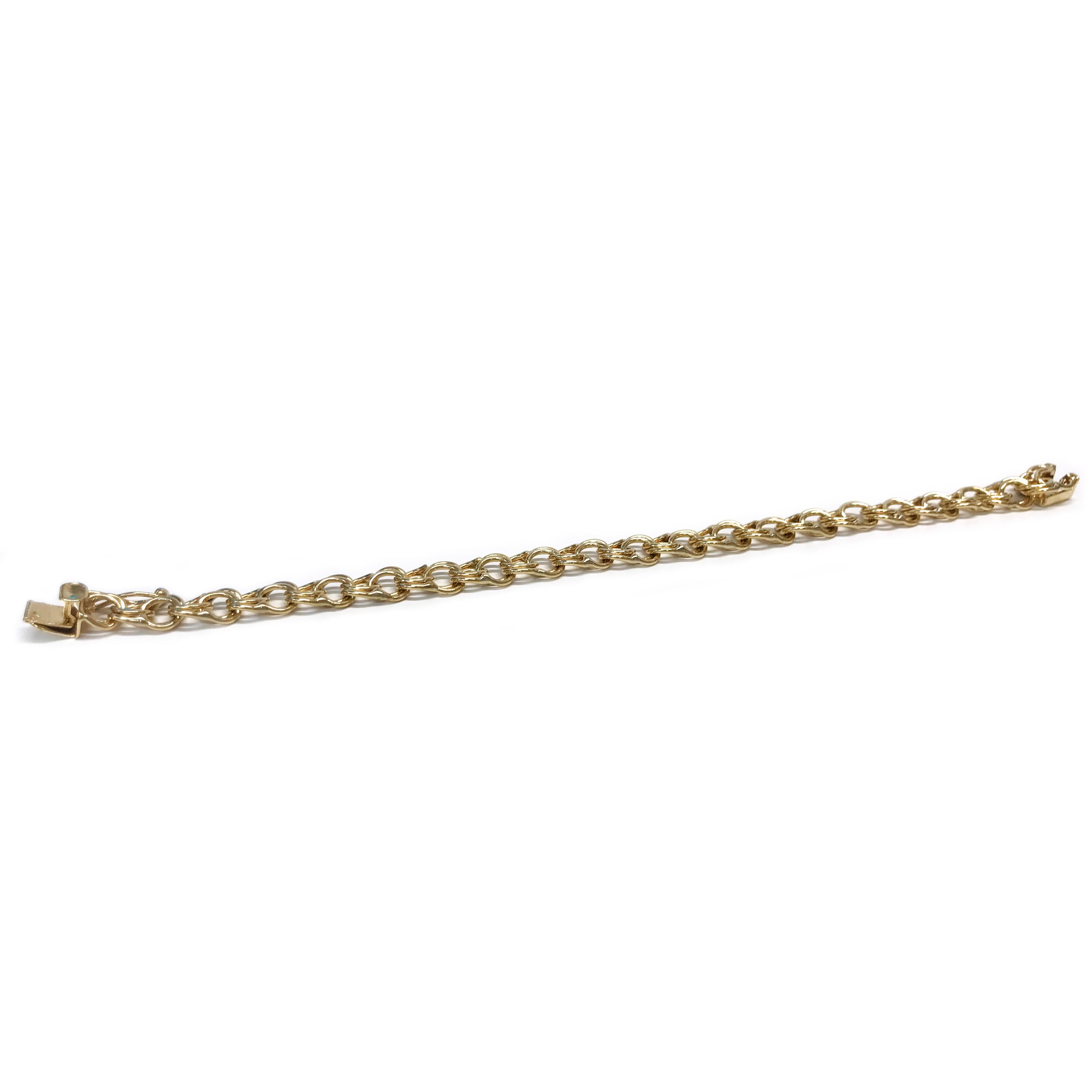 This elegant 14-karat gold charm bracelet showcases a classic double-link design in radiant yellow gold. It offers a secure and comfortable fit, measuring 7 inches in length and 8mm in width. The bracelet is crafted with a sturdy box clasp closure
