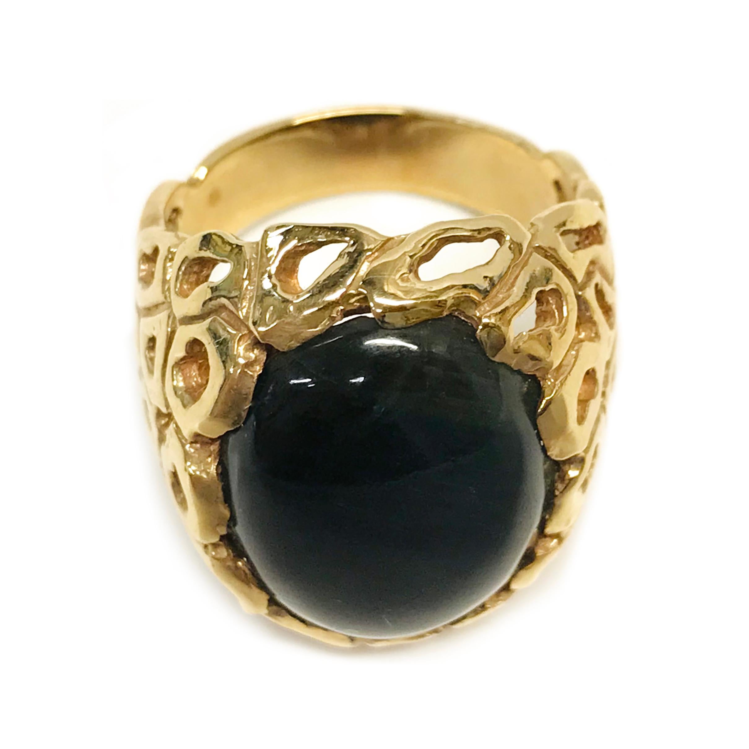 14 Karat Dyed Tiger's Eye Ring. The ring features a bezel-set oval dyed Tiger's Eye stone. The stone measures 19mm x 15.5mm and the ring size is 9. The majority of the ring band has free-form gold shapes with cutouts with a tapered solid band. The