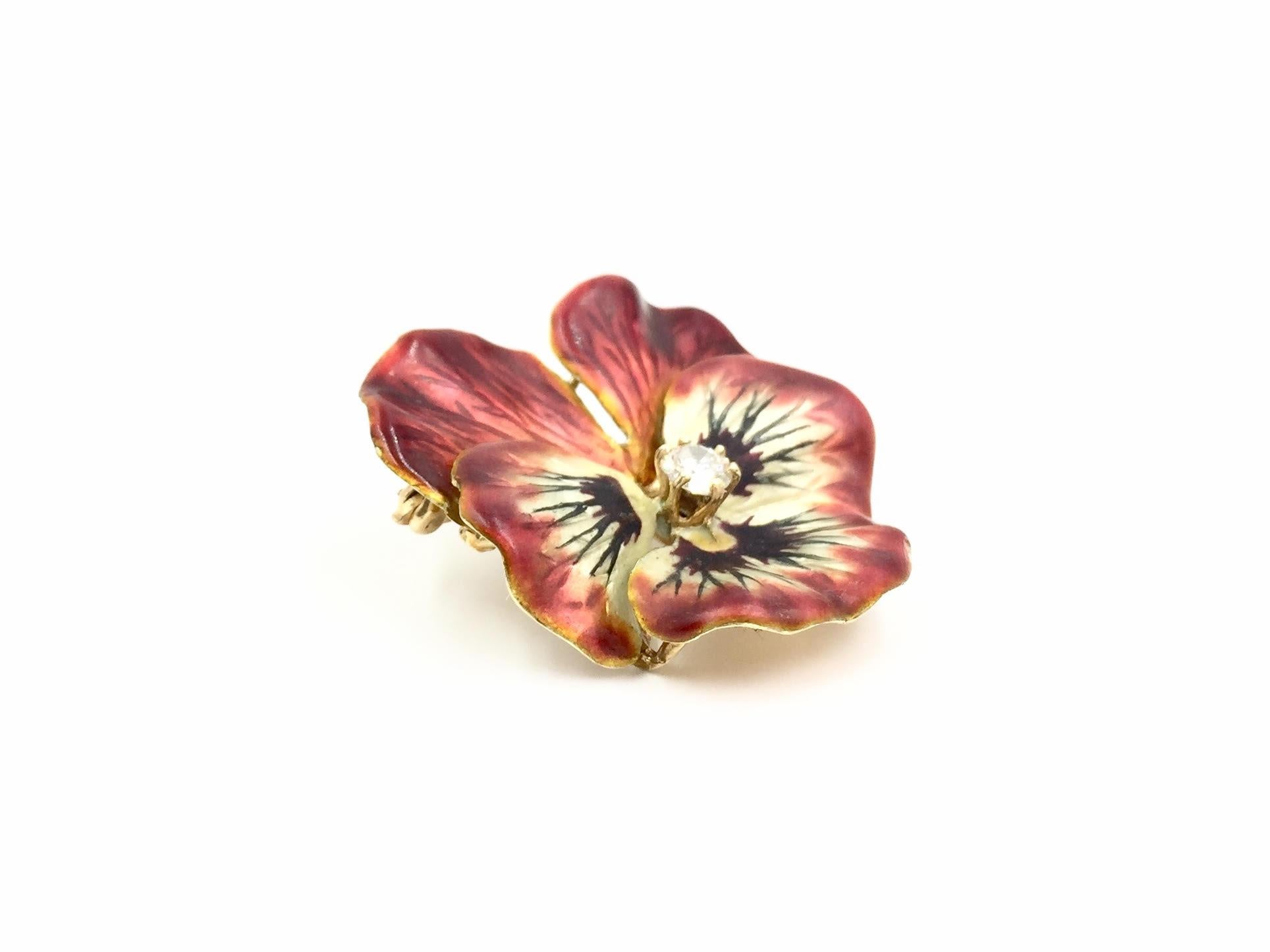 Circa 1950, this 14 karat yellow gold pansy flower brooch doubles as a pendant with a collapsible bale. Pansy features an approximate .25 carat round brilliant diamond at approximately H color, I1 clarity. Hand painted enamel has exquisite detail