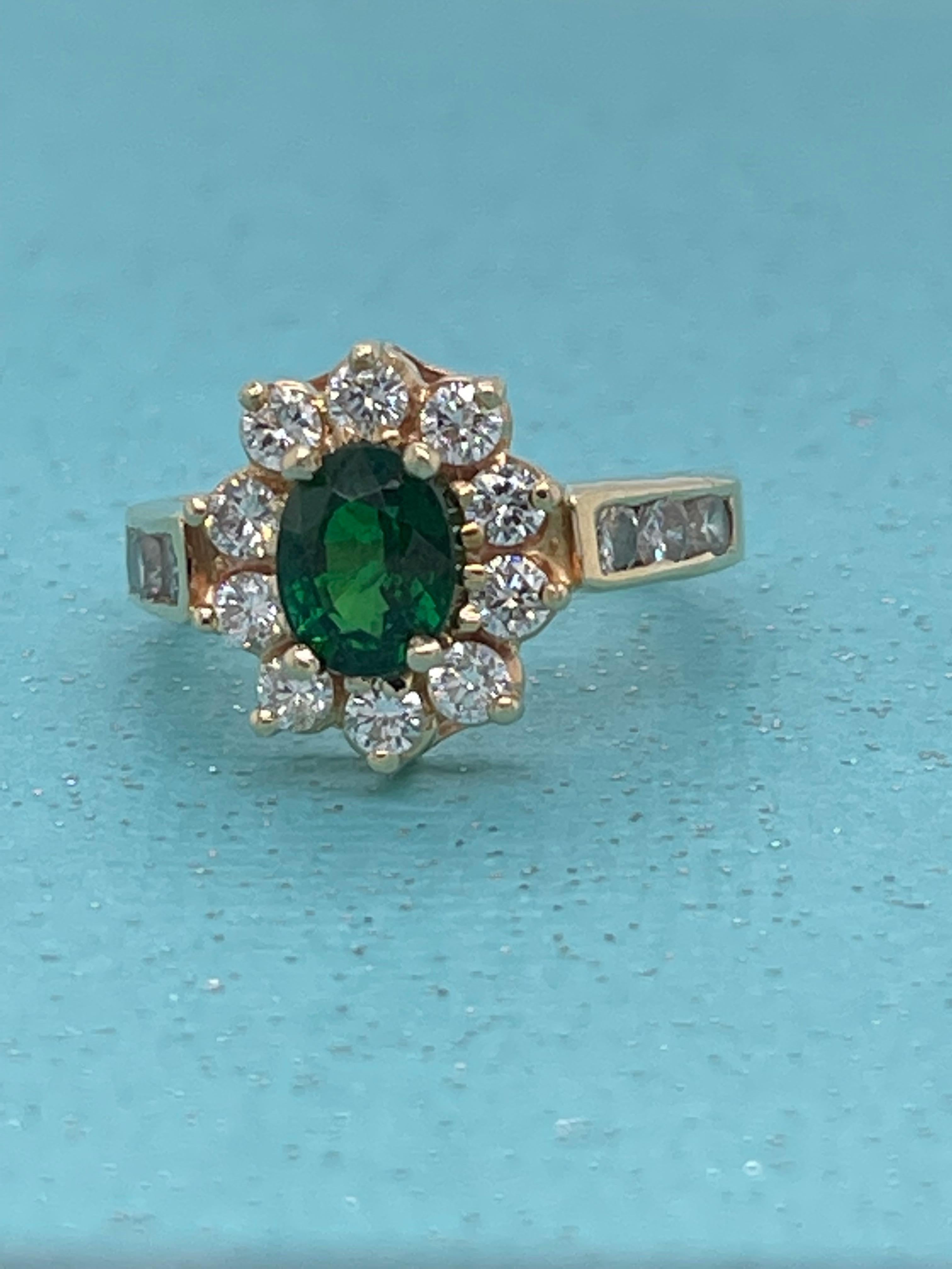Once in a while, we will take in an estate piece from our customers. This 14-karat yellow gold looks like new. The dark green Tsavorite Garnet is from Kenya and weighs 1.05 carat with a VS clarity -almost loupe clean. 
The 10 Diamond halo and the 3