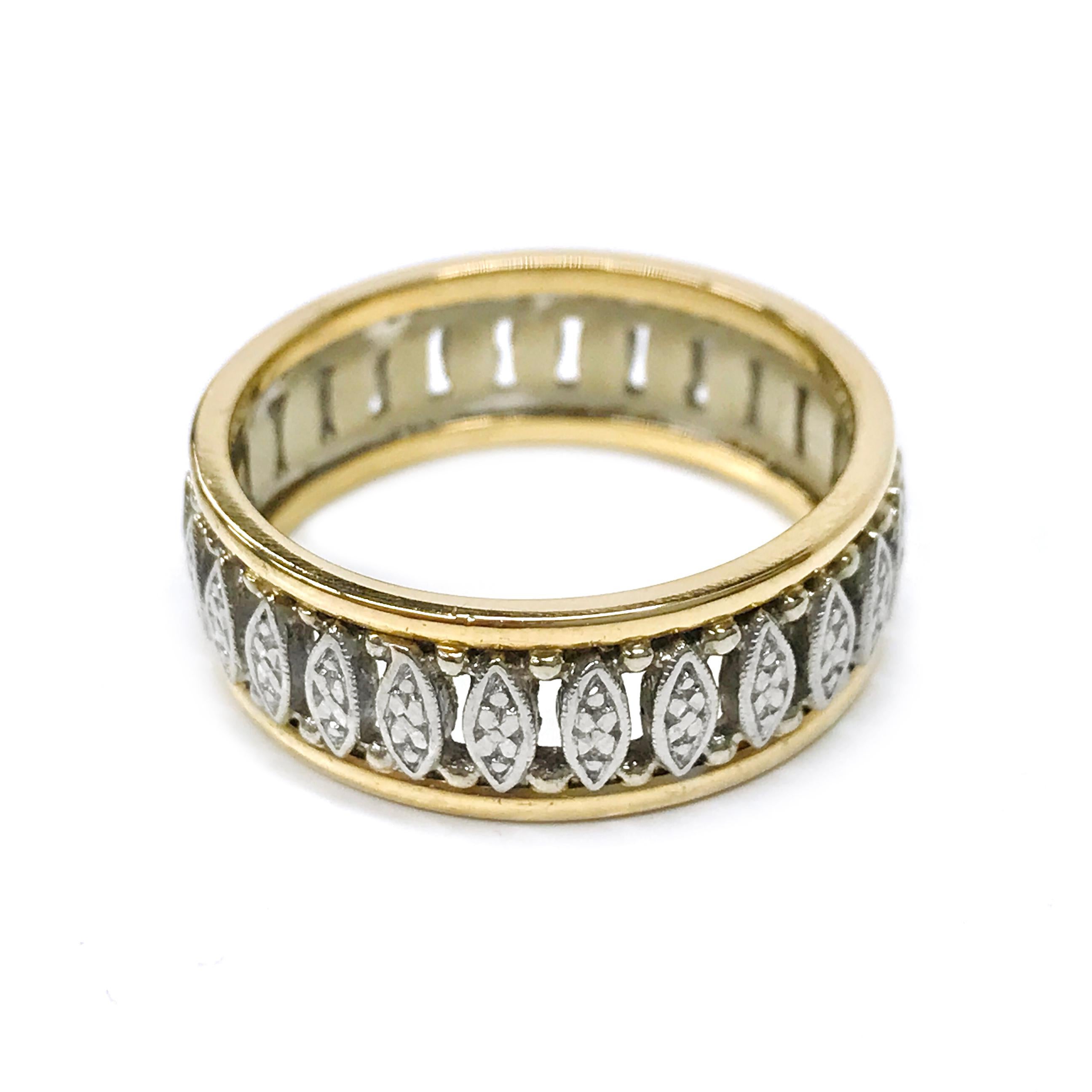 14 Karat Yellow and White Gold Fancy Wedding Band. The ring features a yellow gold band on the top and bottom of the ring with white gold marquise-shaped bars between and white gold beads. The band is 7.5mm wide. The ring size is 10. The total