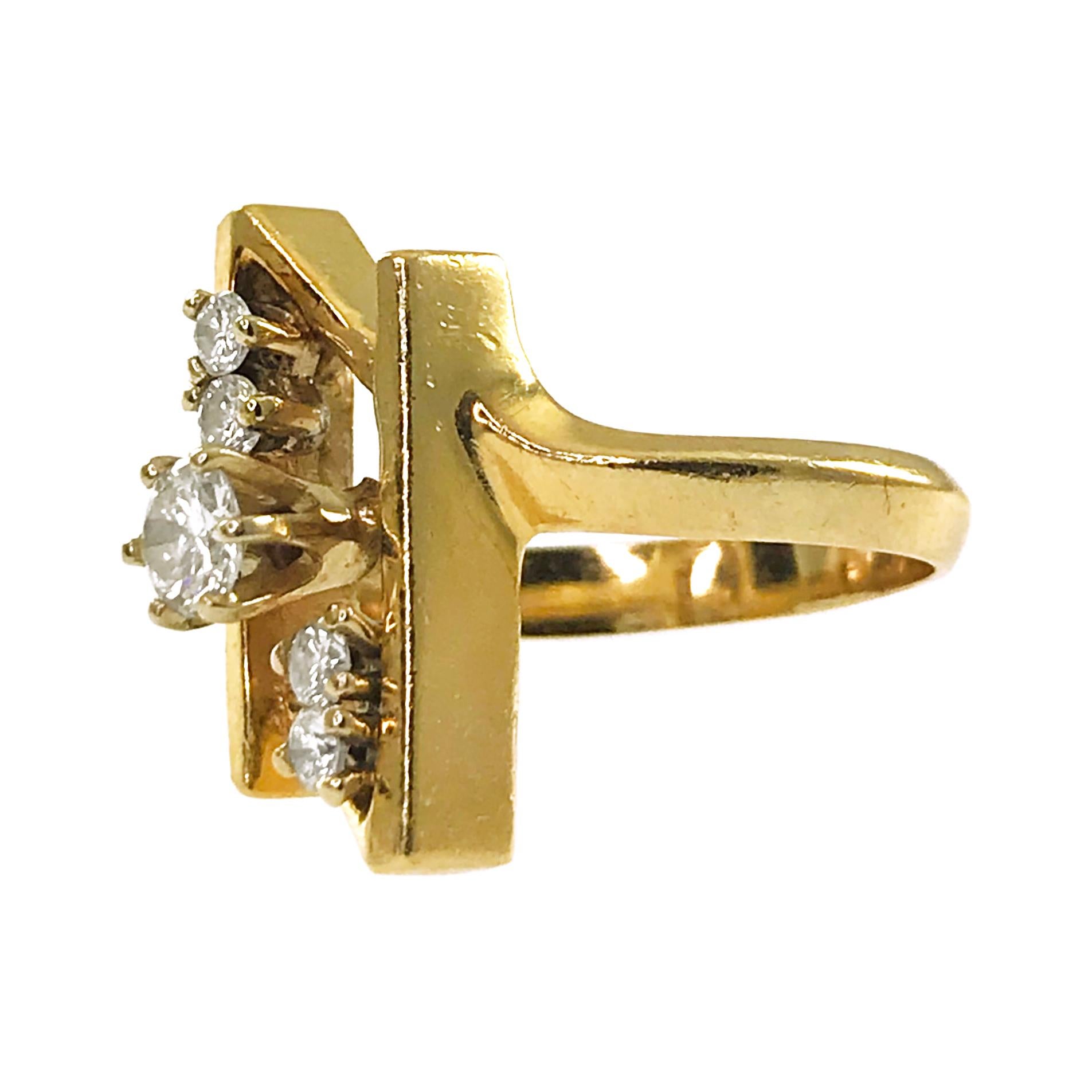 14 Karat Five-Diamond Ring. The ring features two intersecting vertical gold bars with five round diamonds prong-set below. The diamonds are SI1-SI2 in clarity (G.I.A.) and G-H in color (G.I.A.). The center diamond is 3.8mm for a total carat weight