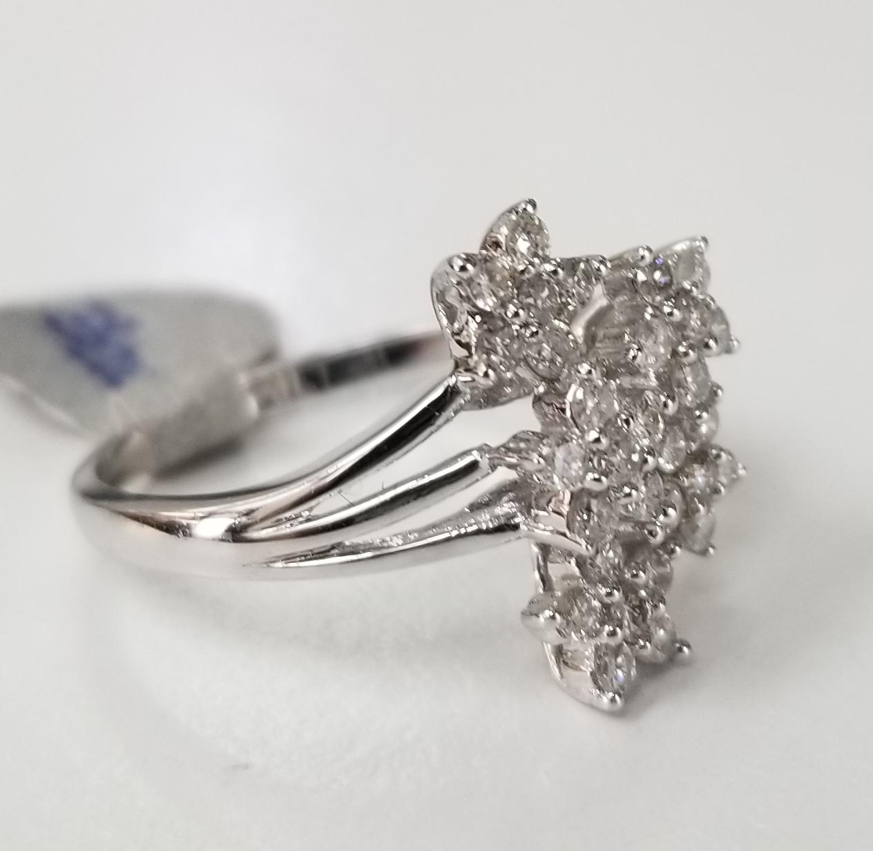 14 karat flower diamond cluster ring, containing 30 round full cut diamonds of very fine quality weighing .65pts.