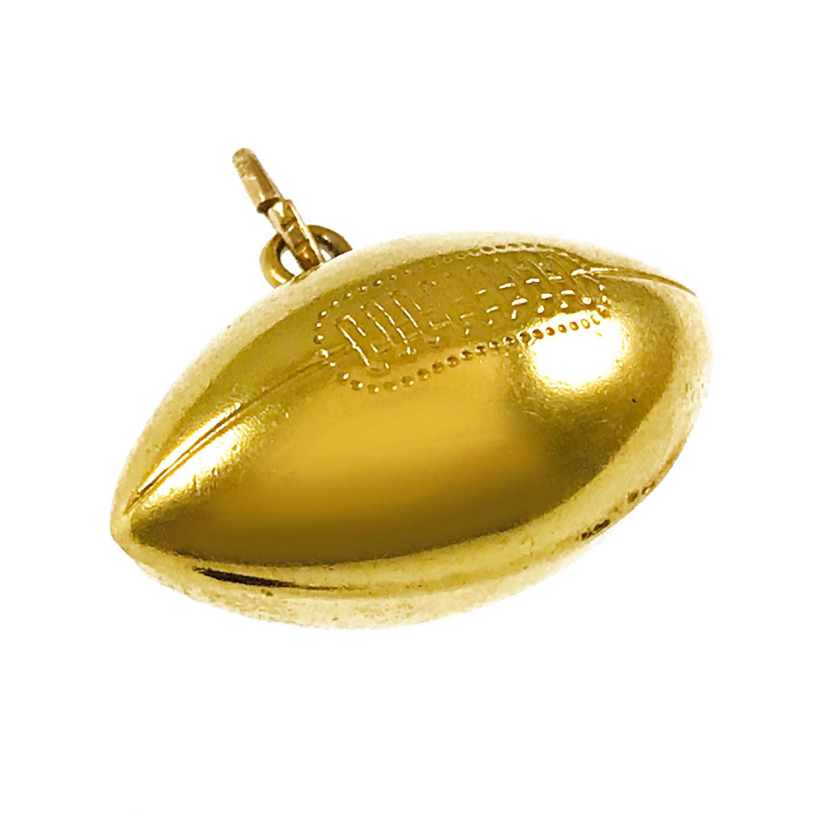 14 Karat Gold Football Pendant. The pendant has detailed laces and seams and an overall smooth finish. The pendant measures 14.65mm tall x 10.9mm wide x 22.0mm long. This vintage pendant/charm weighs 2.6 grams.