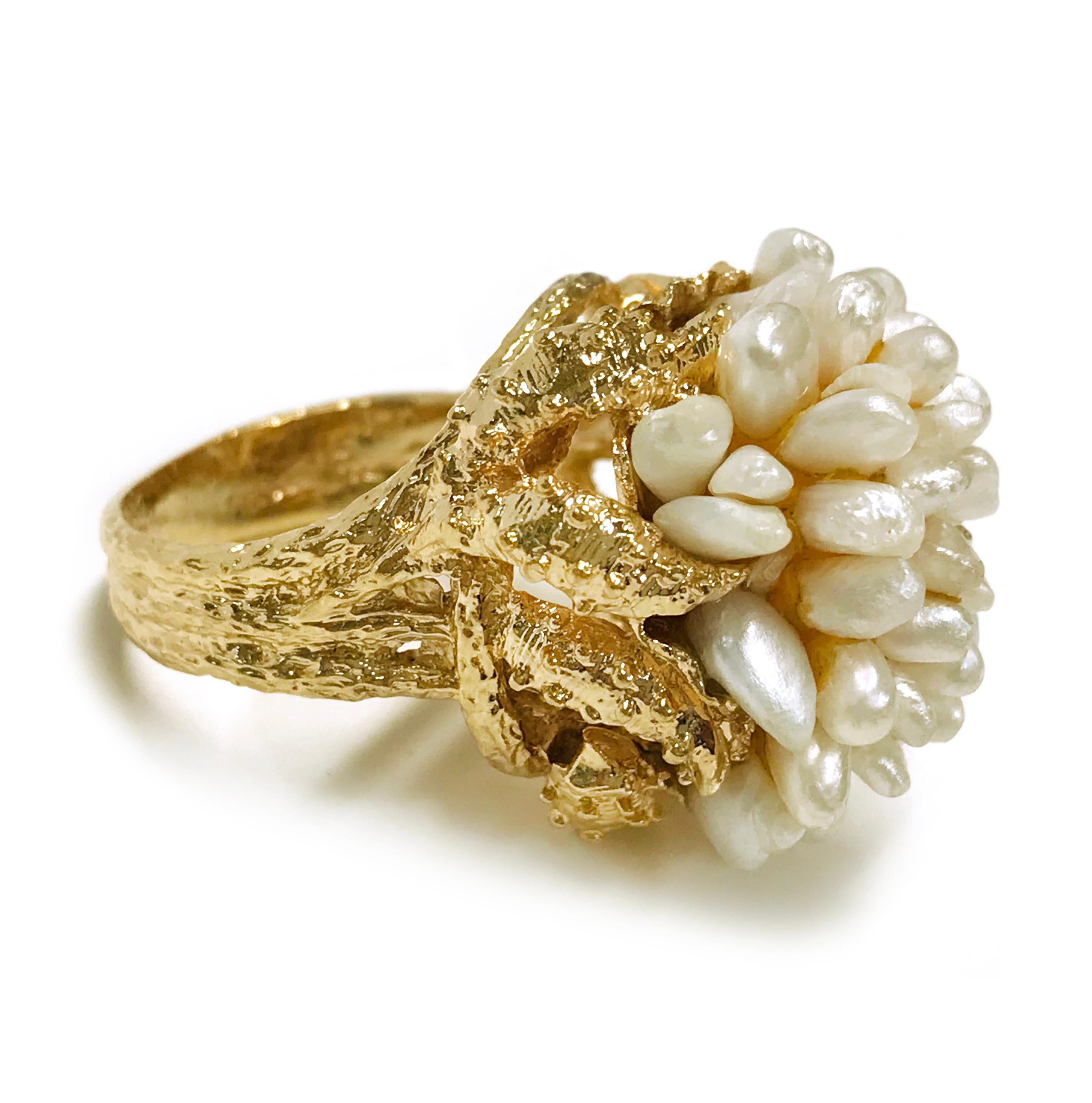14 Karat Freshwater Pearl Cluster Ring. This three-band split ring features forty freshwater pearls. The pearls are creamy-white and have good luster. The ring size is 7 1/4. The total gold weight of the ring is 18.05 grams.