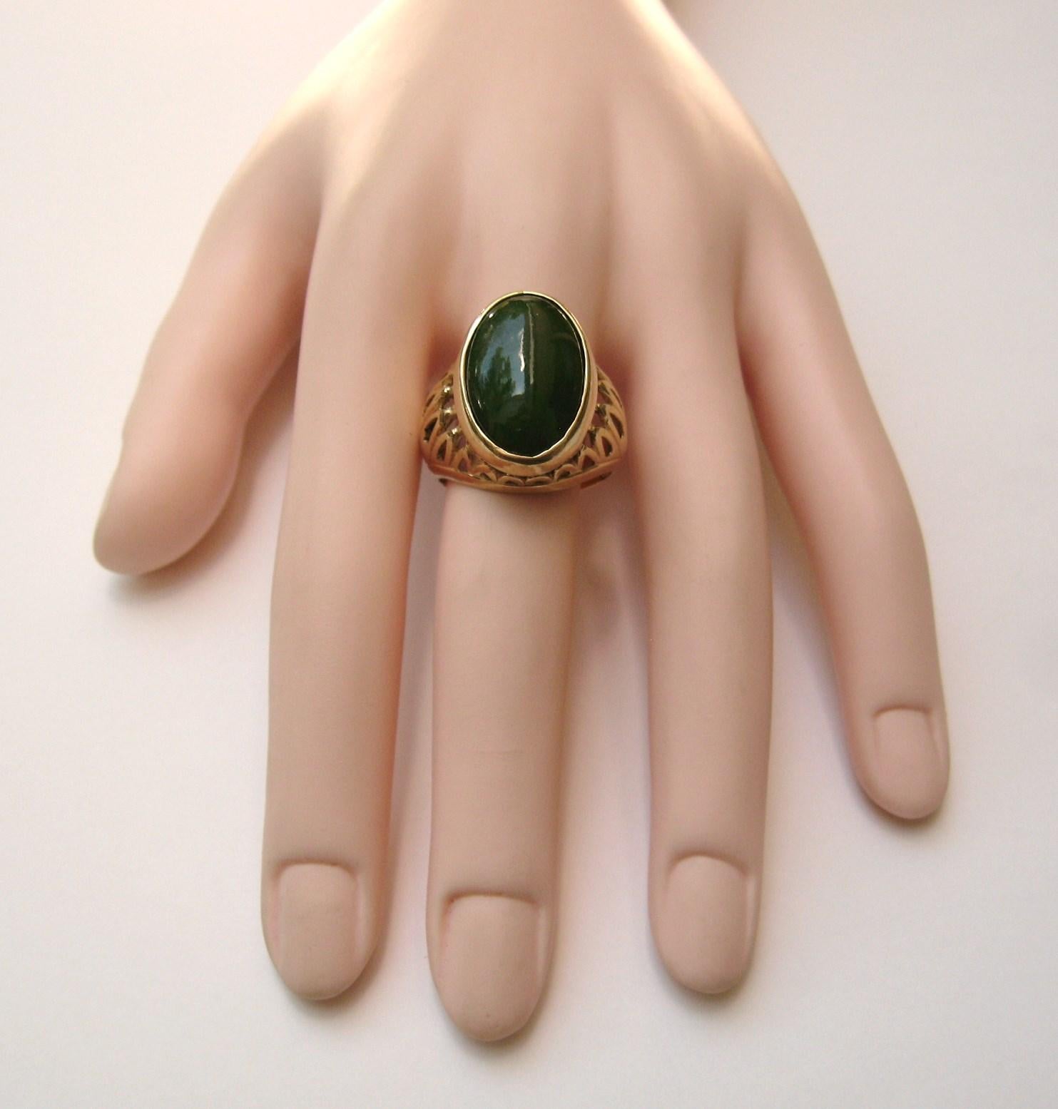  Stunning oval Jade set in a 14 Karat Gold Setting made by Karbra 62, a premier New York City fine jewelry maker, in the 1960s. It sits up high .50