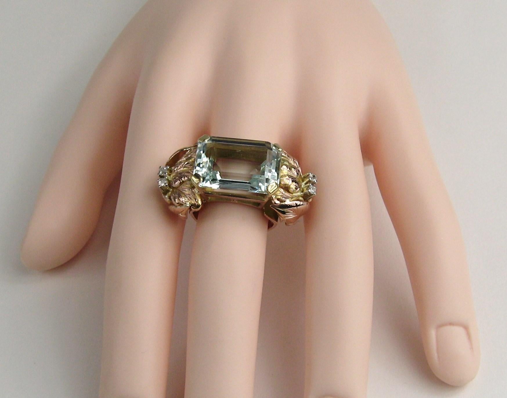 This is a amazing ring. Large Aquamarine approximately 13.75 Carats set in a stunning 14K gold basket setting with leaf accents (mixed rose gold & Yellow Gold) with diamond accents on both sides. Ring is a size 7.5 and can be sized by us or your