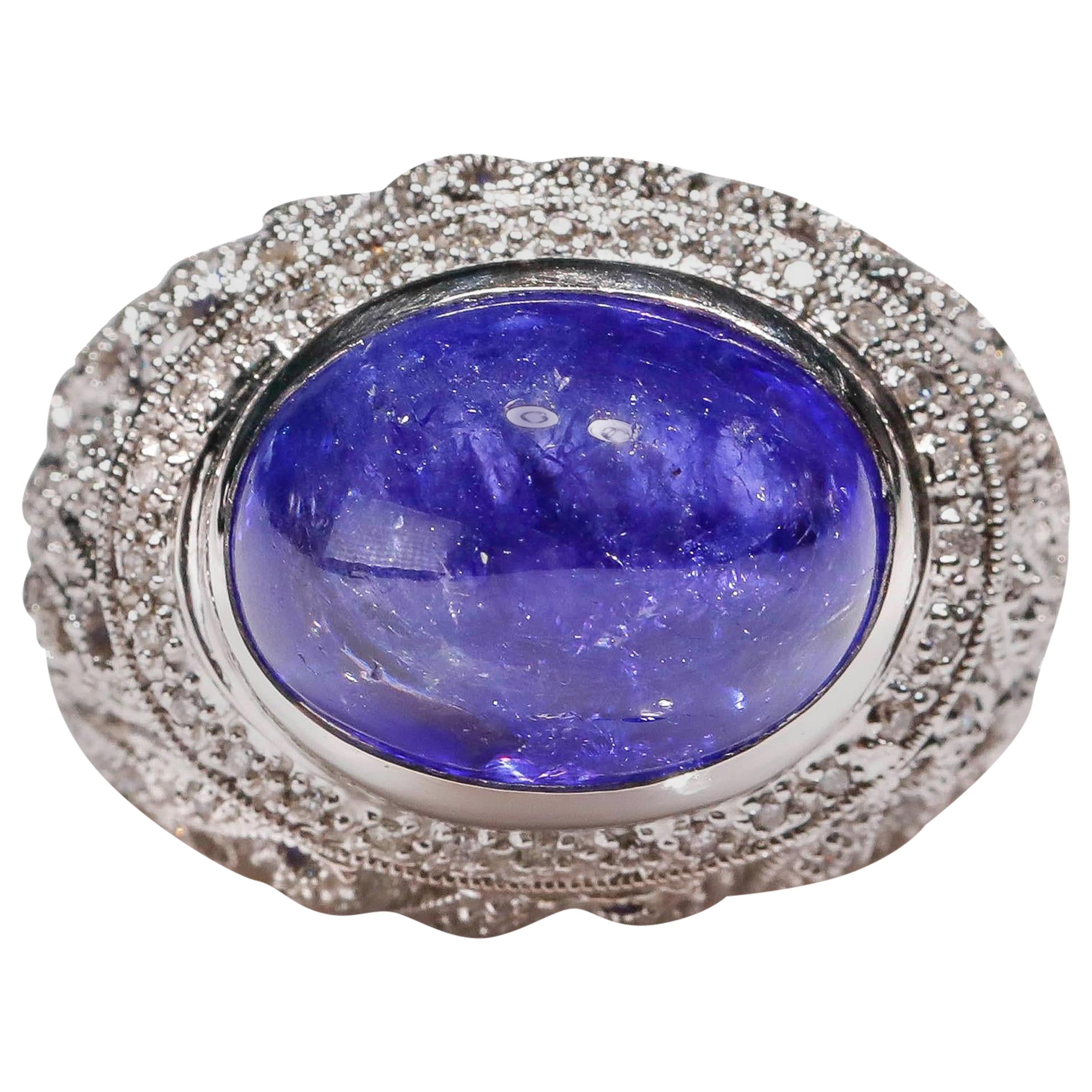 Anillo de cóctel de oro blanco de 14 quilates con tanzanita de 1,3 quilates de diamantes en cúpula redonda

Elaborado en Oro Blanco de 14 quilates, este diseño Único muestra diseños de Tanzanita, engastados en un halo de diamantes hipnotizadores de