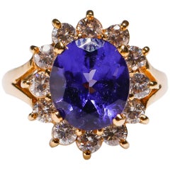 14 Karat Gold 3.3 Carat Oval Cut Tanzanite 1.1 Carat Diamond Flower Bridal Ring