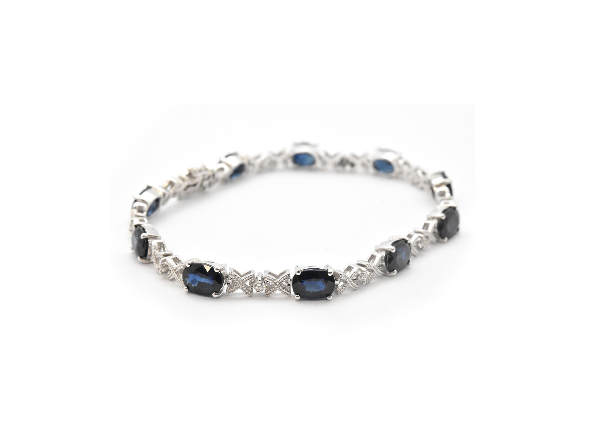 This sapphire and diamond “X” style bracelet is designed in 14k white gold and set with 10 oval cut sapphires and accented with 10 round brilliant diamonds. In between each sapphire and diamond is an “X” with a granulated texture. Diamonds reach