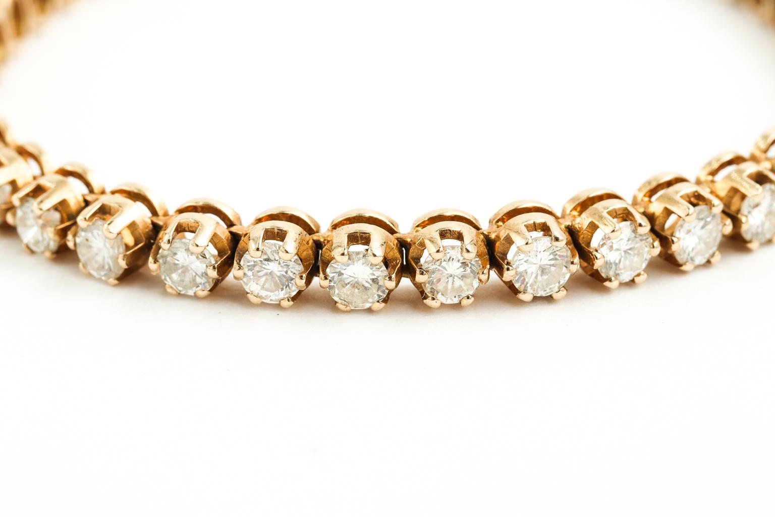 Circa mid-20th century handmade full cut diamond bracelet in 14 karat yellow gold with 7.20 total carats set into each section. Diamonds are excellent quality, near colorless in white US 1. There is a safety clasp in the closure. The bracelet