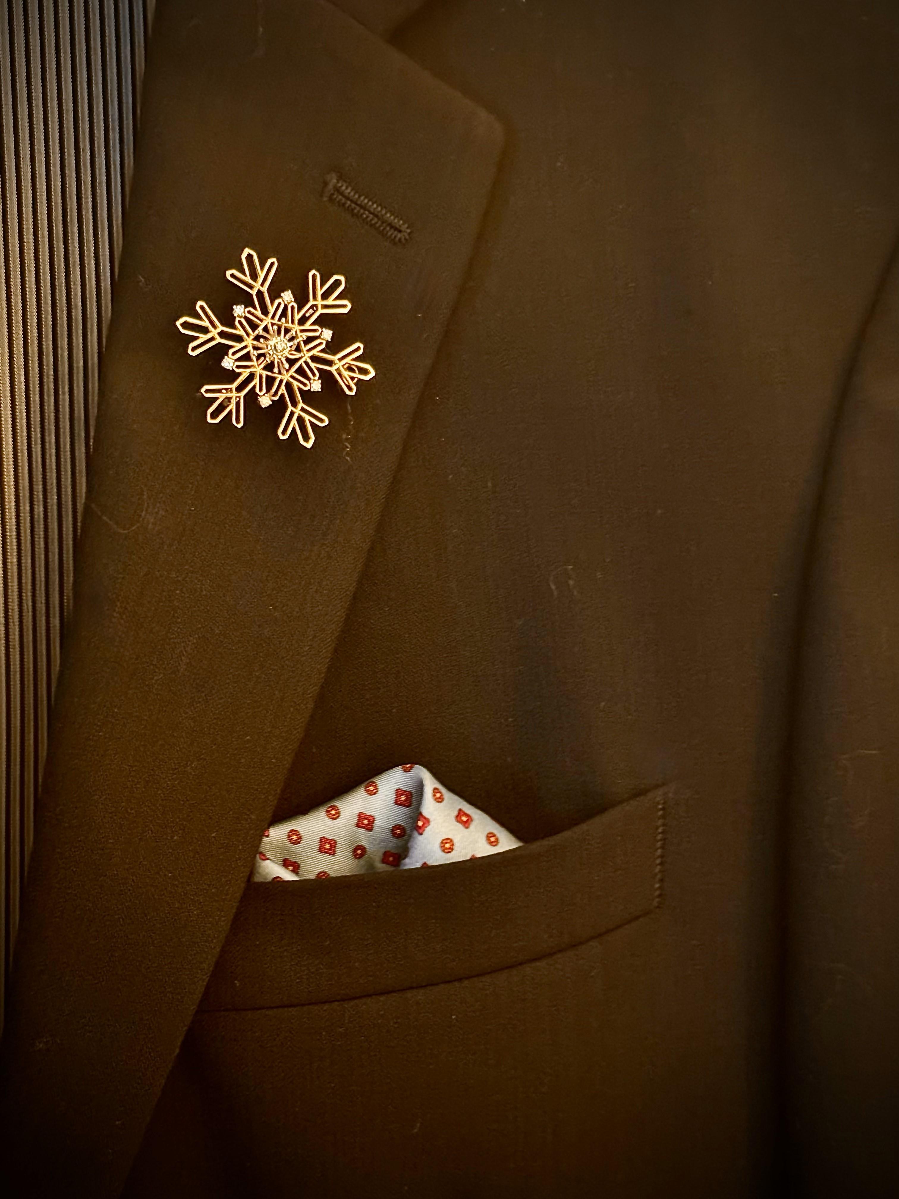 Whimsical 14 kt. gold and diamond brooch. Brooch is amusingly formed as a delicate snowflake with sparkling white diamonds. Circa 1960's - '70s. Lightweight and easy to wear brooch which work well for either a lady or a man's lapel pin, as