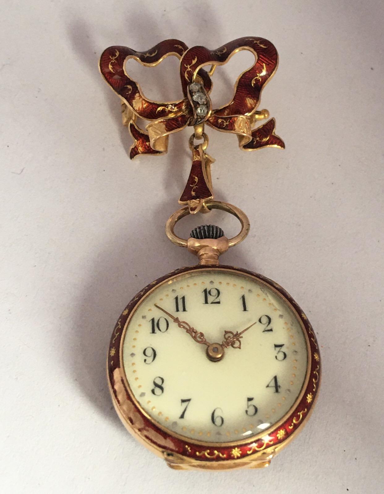 This beautiful antique 28mm diameter hand winding gold and diamond ladies brooch watch is in good working condition and it is running well. Visible signs of ageing and wear with light and small scratches on the enamel case and a tiny marks on the