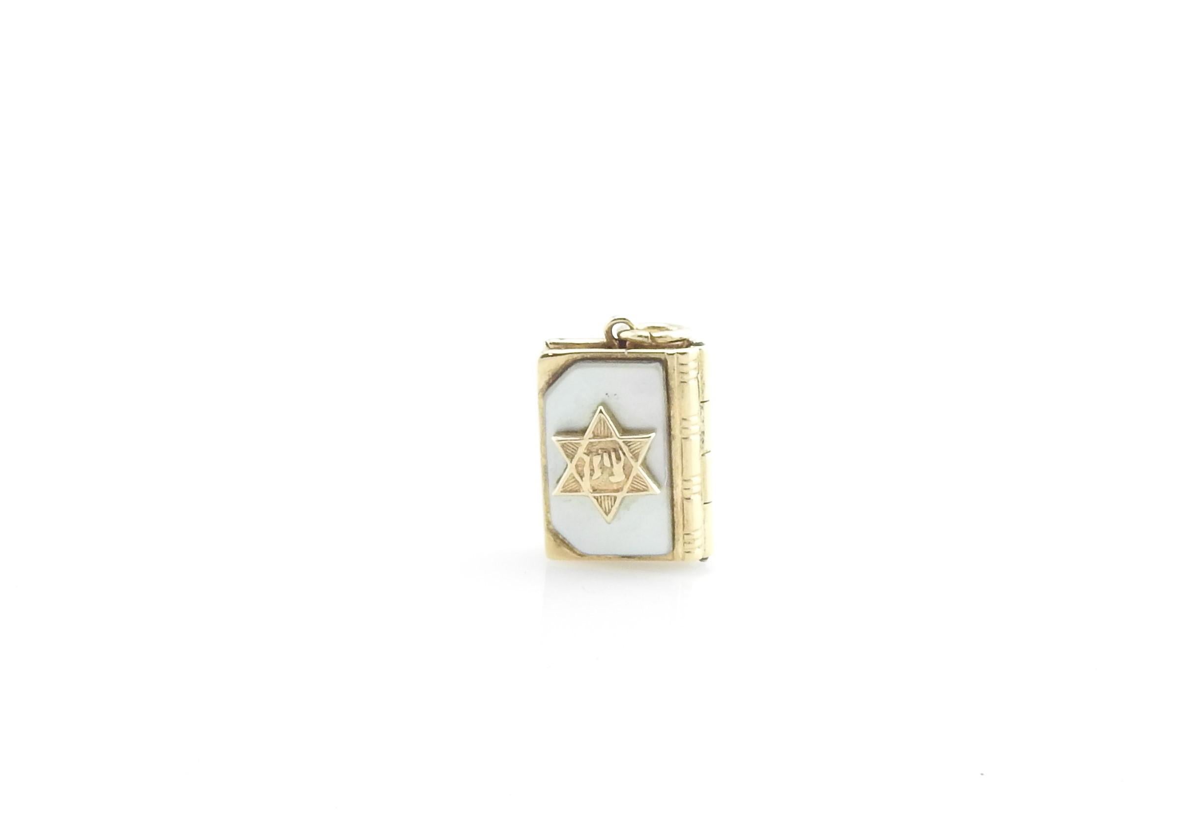 Vintage 14 Karat Yellow Gold and Mother of Pearl Star of David Prayer Book Charm

This lovely 3D charm features a prayer book with the Star of David on its cover. Opens to reveal prayer in Hebrew*. Meticulously detailed in 14K yellow gold and mother