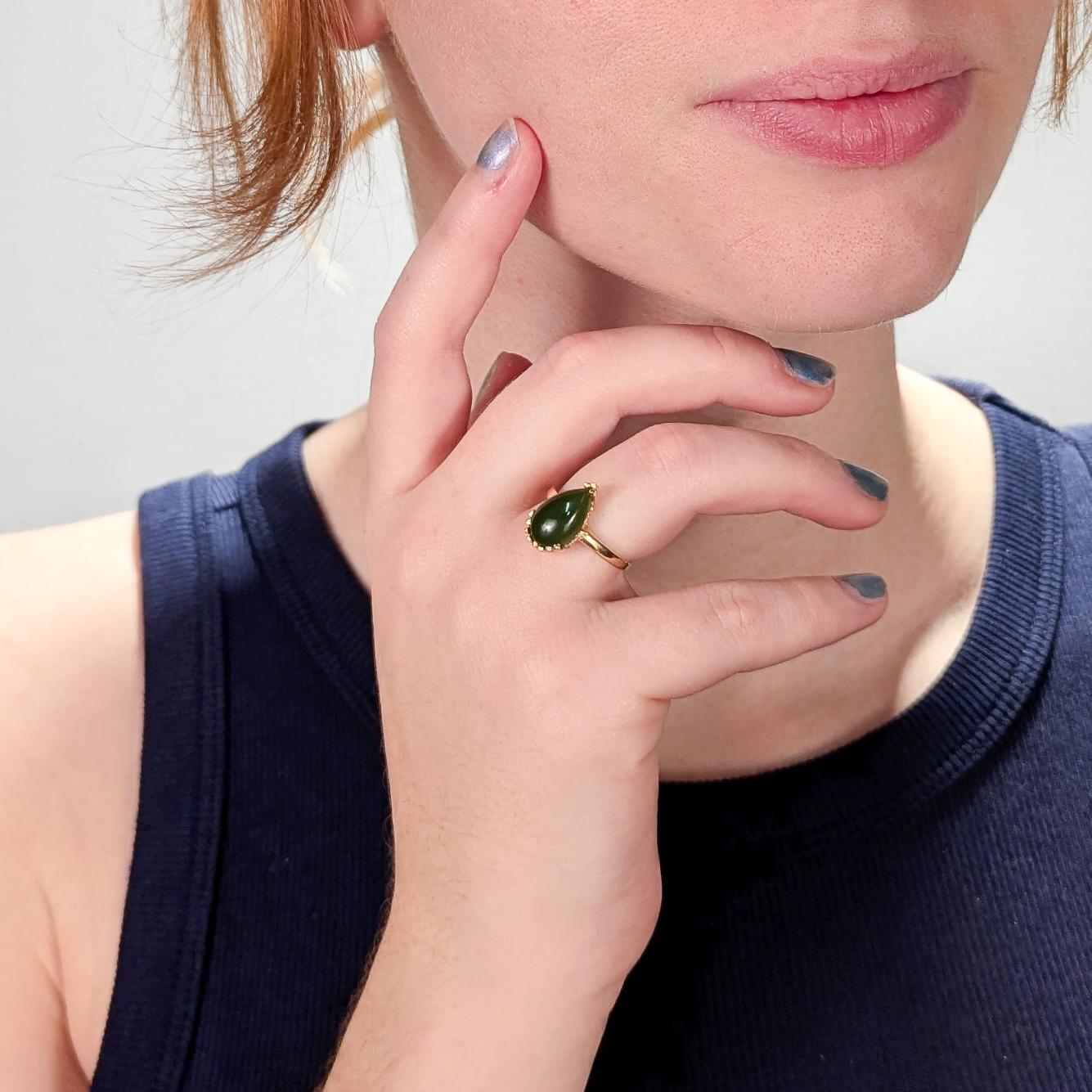 A very fine 14k gold and nephrite jade ring.

With a pear shaped smooth nephrite jade cabochon that is prong set in a 14k gold clam shell like setting.

A refined and beautiful ring!

Date: 
20th Century

Overall Condition:
It is in overall good,