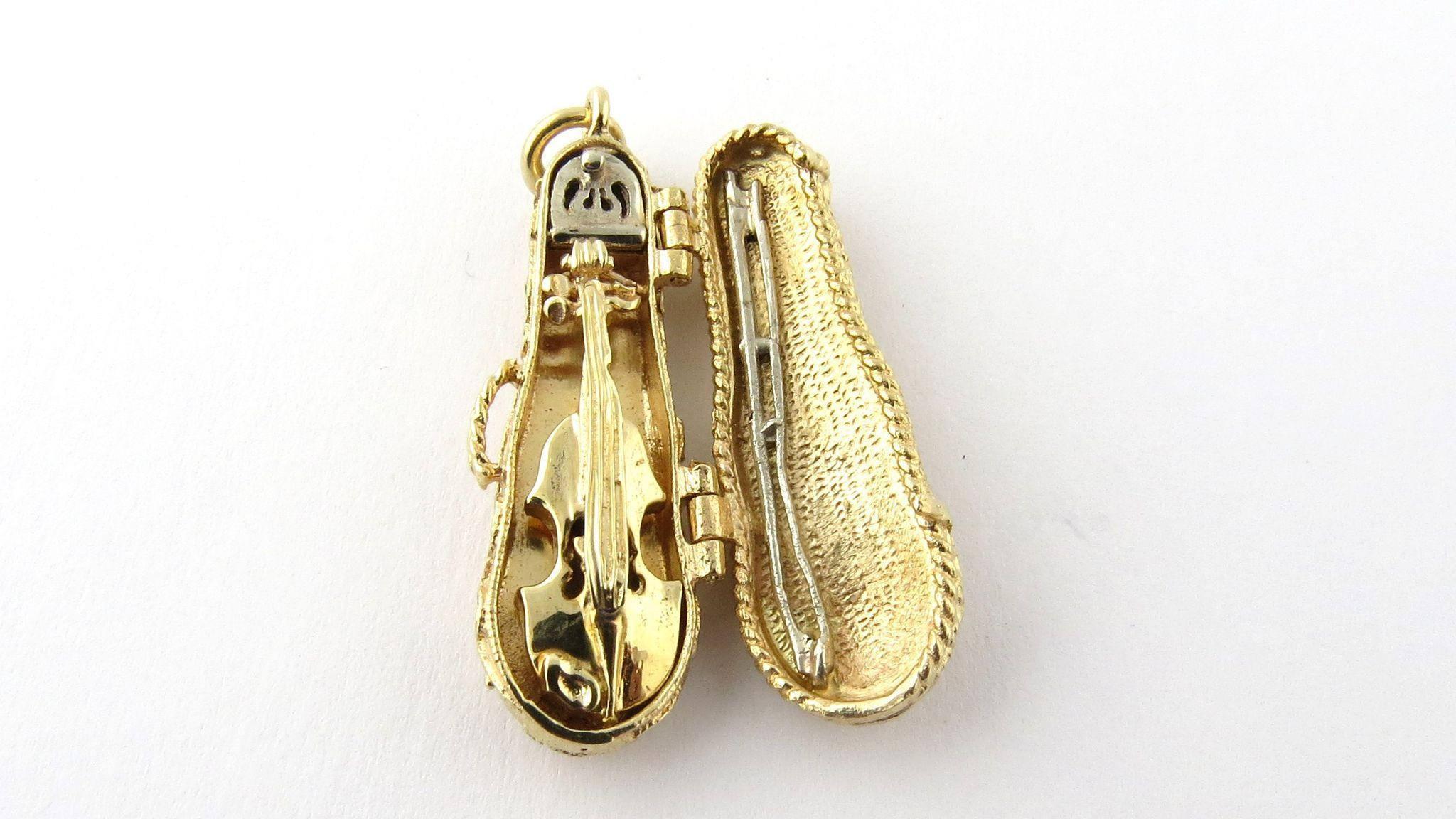 Vintage 14K Yellow Gold and Turquoise Violin Pendant / Charm in Violin Case with Bow 

38 mm in length from top of bale About 9 mm thick and 11mm wide

Beautiful scrolling design on case including 5 small turquoise stones. 

Inside the case is a