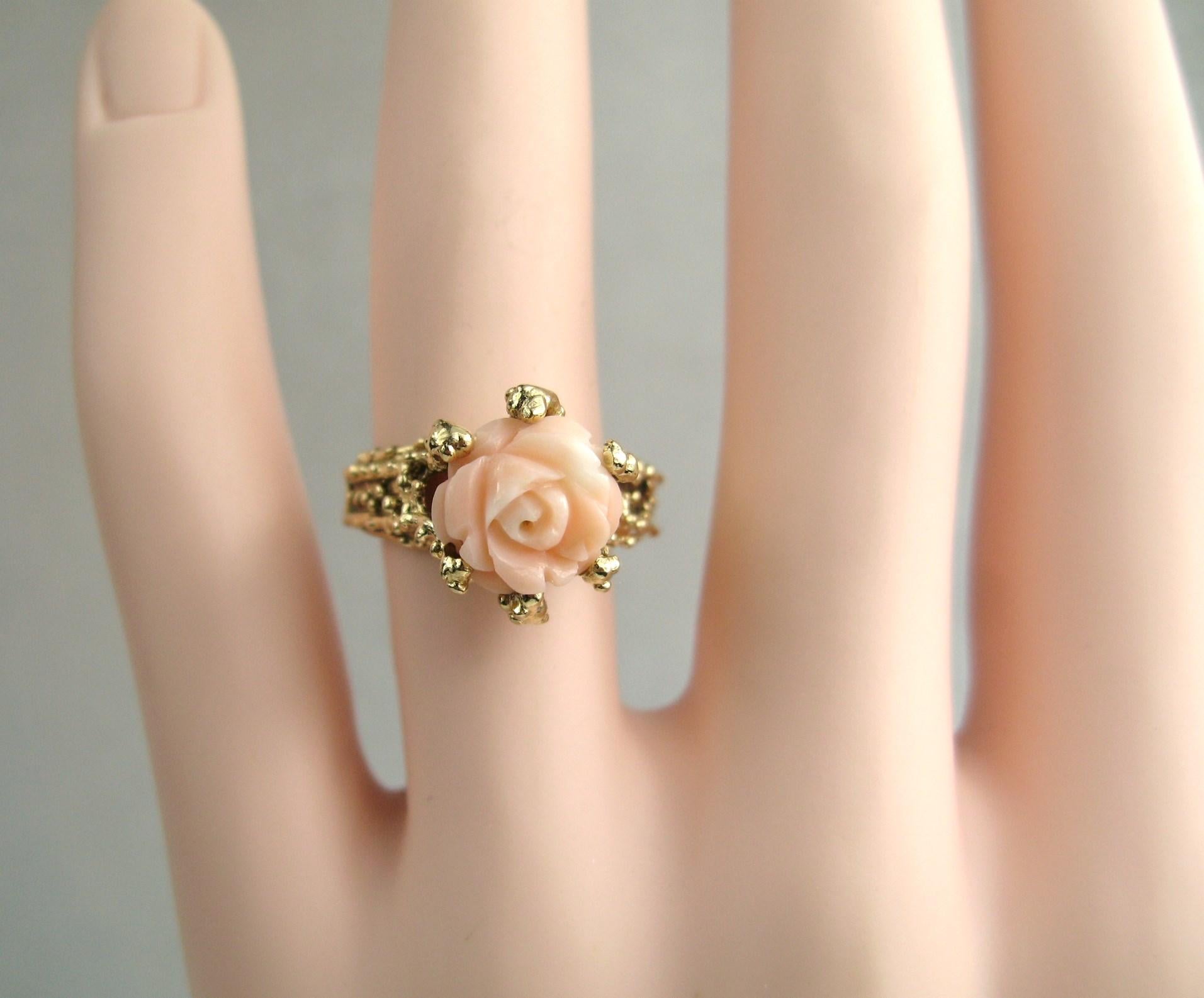 Lovely Carved Angel coral Rose set in a 14K yellow gold nubbed Ring. The ring is a size 7.5 and can be sized by us or your jeweler.  The Rose stands up .40