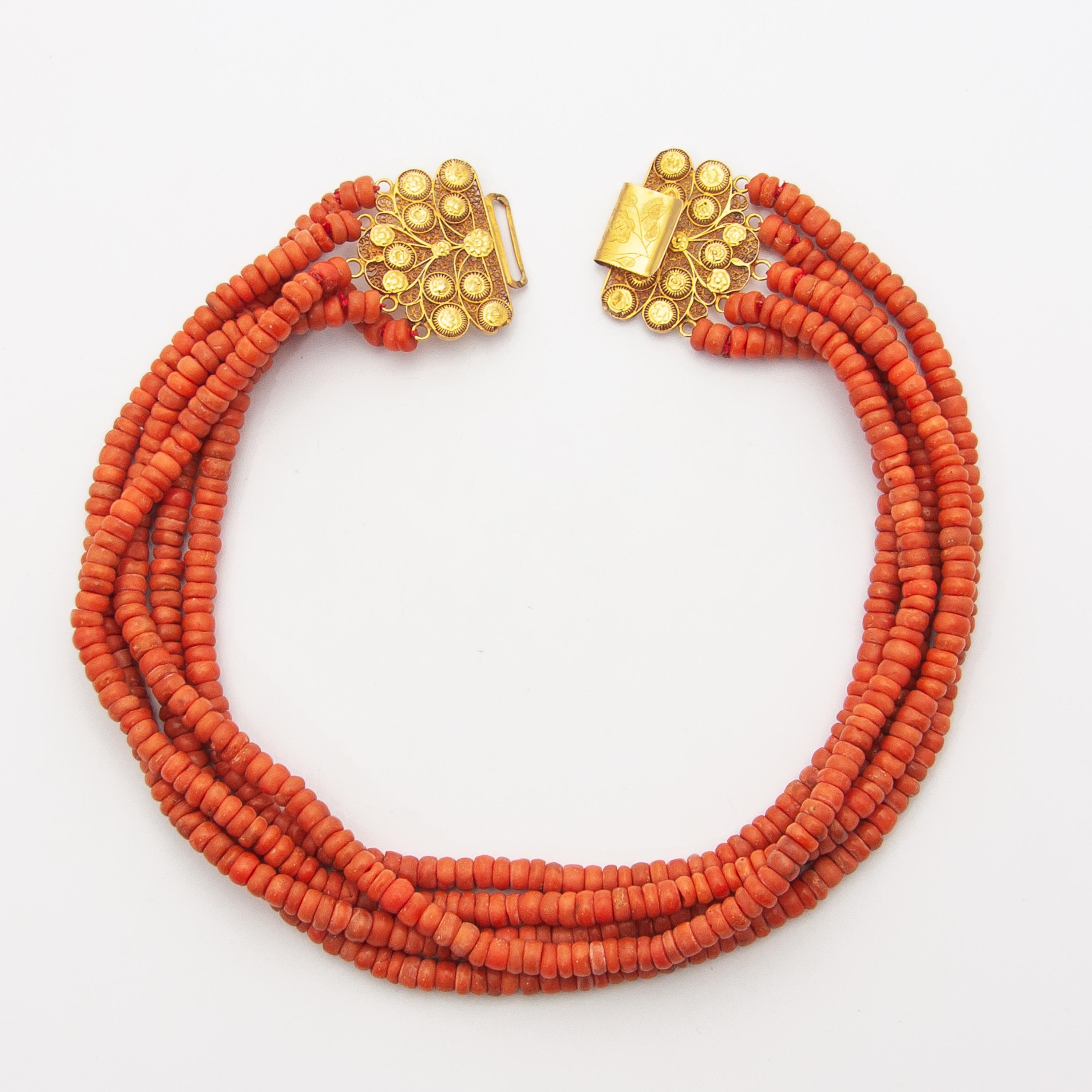 An antique 19th century natural coral necklace created with an impressive large worked 14 karat gold clasp. The clasp is beautifully made of fine filigree and cannetille work, the craftsmanship is stunning. The closure of the clasp is engraved with