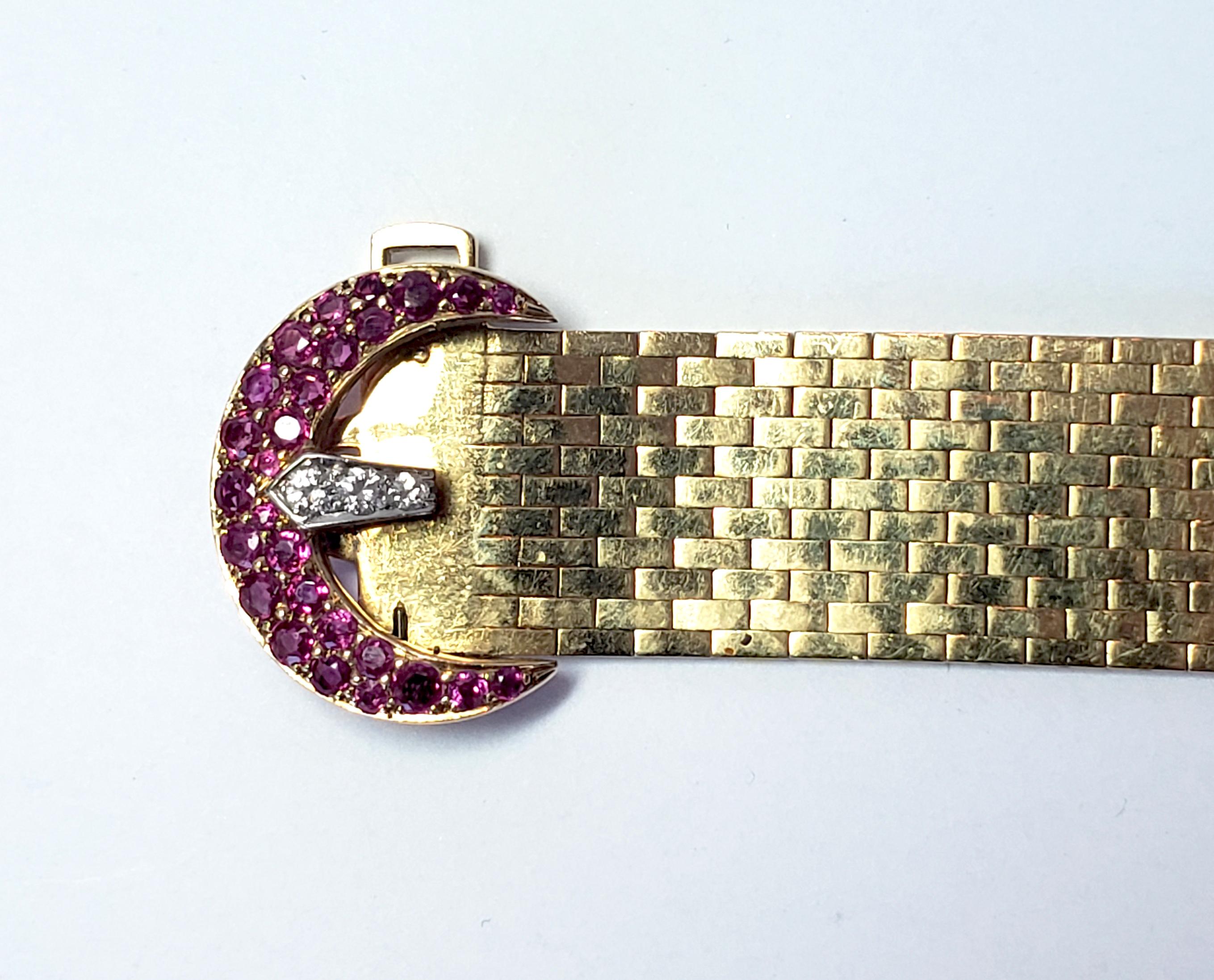 Beautiful Art Deco flexible band buckle 14 karat gold adjustable bracelet with diamonds and rubies on the buckle and end. Stamped 14K.
Circa 1930

Size:  L:  8”  W: 5/8”
Weight:  42.5 Grams