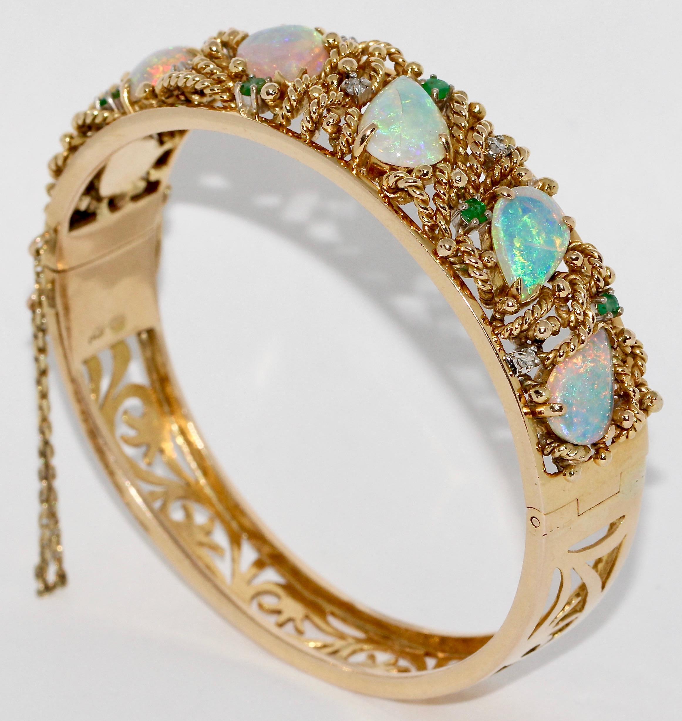 14 Karat Gold Bangle, Bracelet, with Opals, Diamonds and Emeralds.

The six natural full opals are in drop-cut.
Very fine goldsmith work.