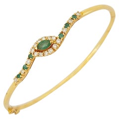 14 Karat Gold Bangle Bracelet with.85 Carat Emeralds and .33 Carat Diamonds