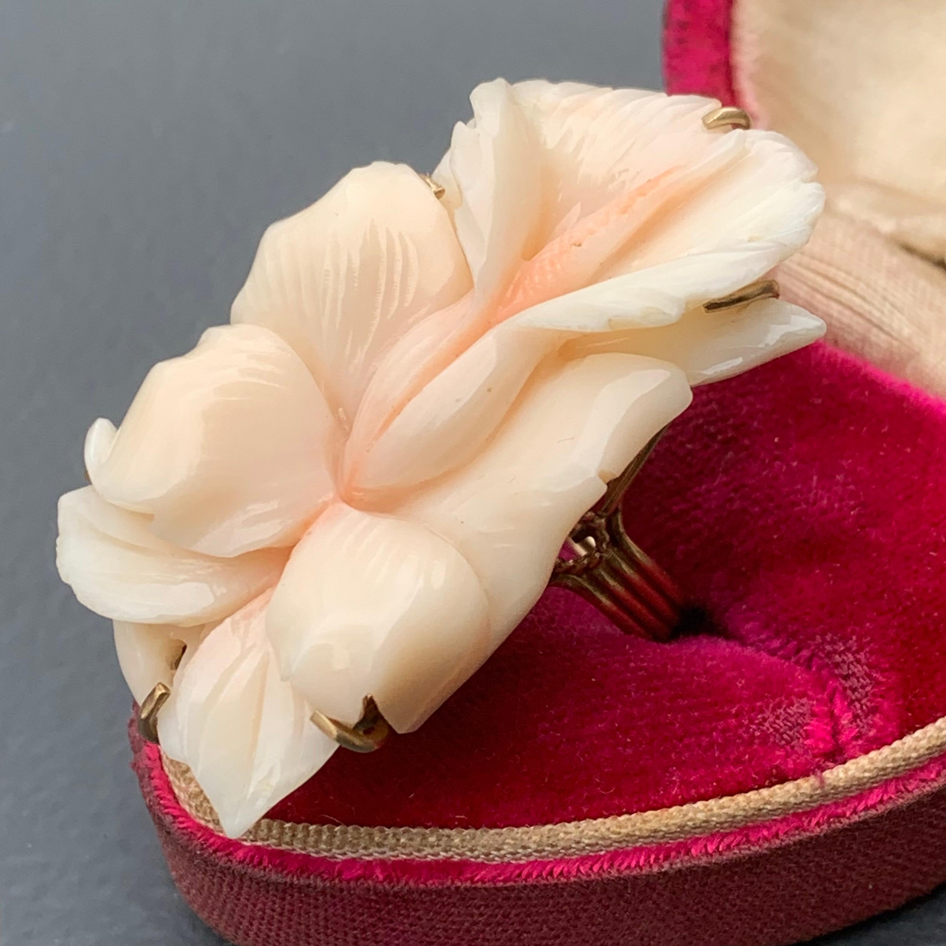 Fabulous detail on this MASSIVE solid 14kt gold , carved coral dinner /cocktail ring . Ring is handmade and handmade most likely in Italy . Huge finally carved angel skin coral orchid flower is set on an open-back , prong set raised gold settings