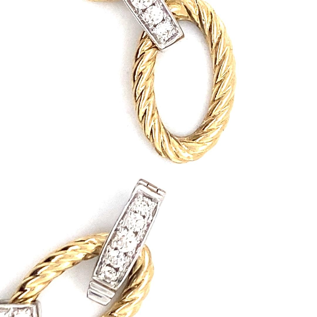 This two-tone bracelet is made of 14 karat gold and has a total diamond weight of 1.65cttw. The yellow gold oval links gave the bracelet and chain-like feel with their rope texture. While white gold diamond links add a beautiful sparkle to the