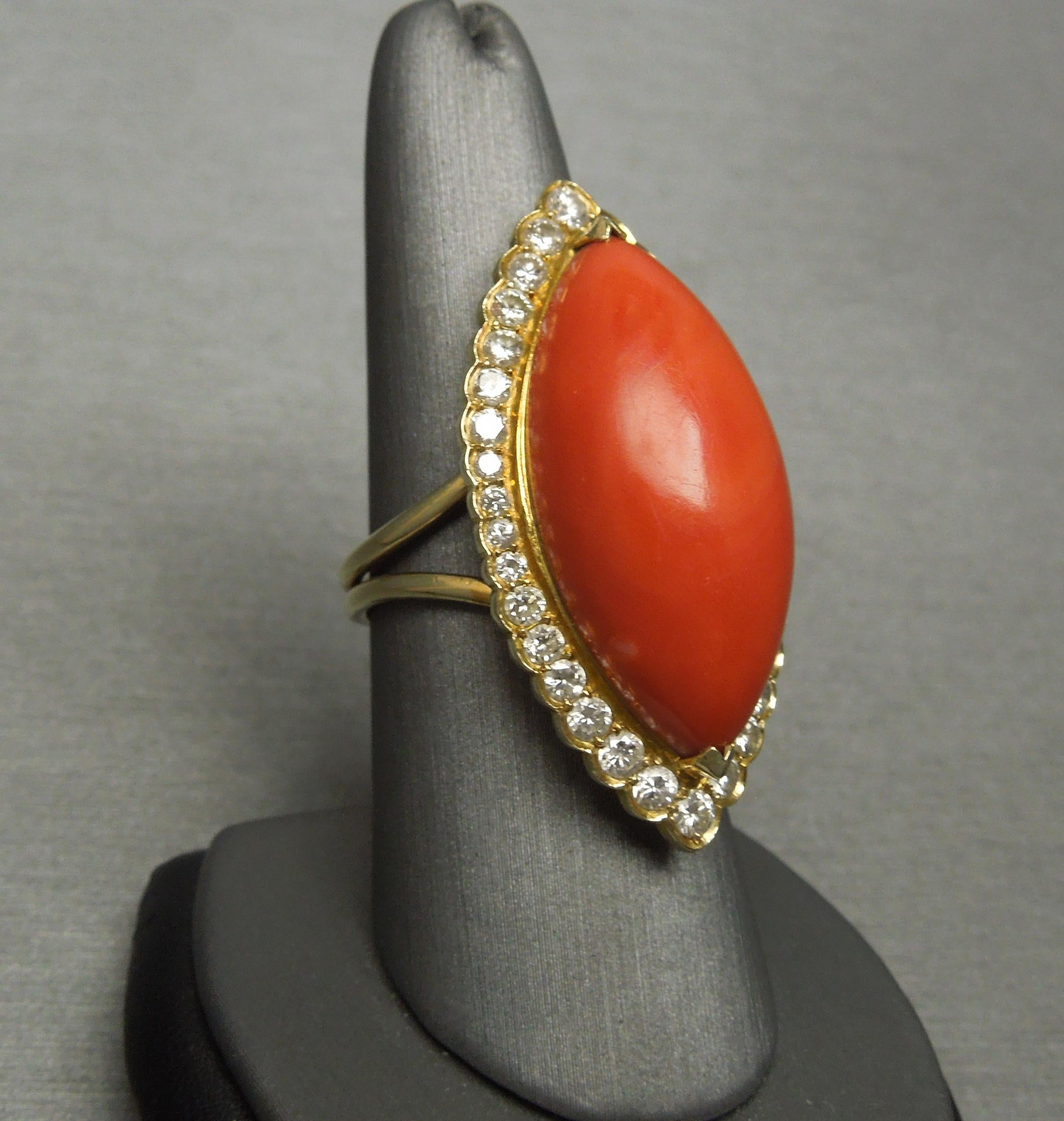 Featuring 1 Focal Marquise-shaped piece of Natural Red Coral
measuring approximately 31.8mm in length x 13.9mm at widest

Bordered by a total of approximately 2 carats of
Colorless Nearly Flawless Round Brilliant cut Diamonds
ranking an E-F Color &
