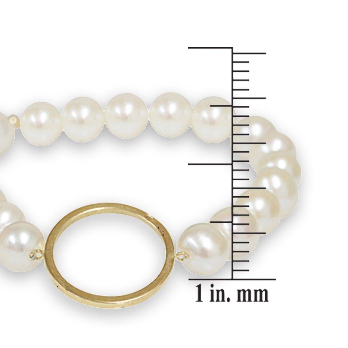 Classic and elegant, this beautiful bracelet is crafted from a strand of lustrous white freshwater pearls. The delicate round pearl strand is enhanced by large 14-karat yellow gold circle that adds a contemporary twist to this beautiful and