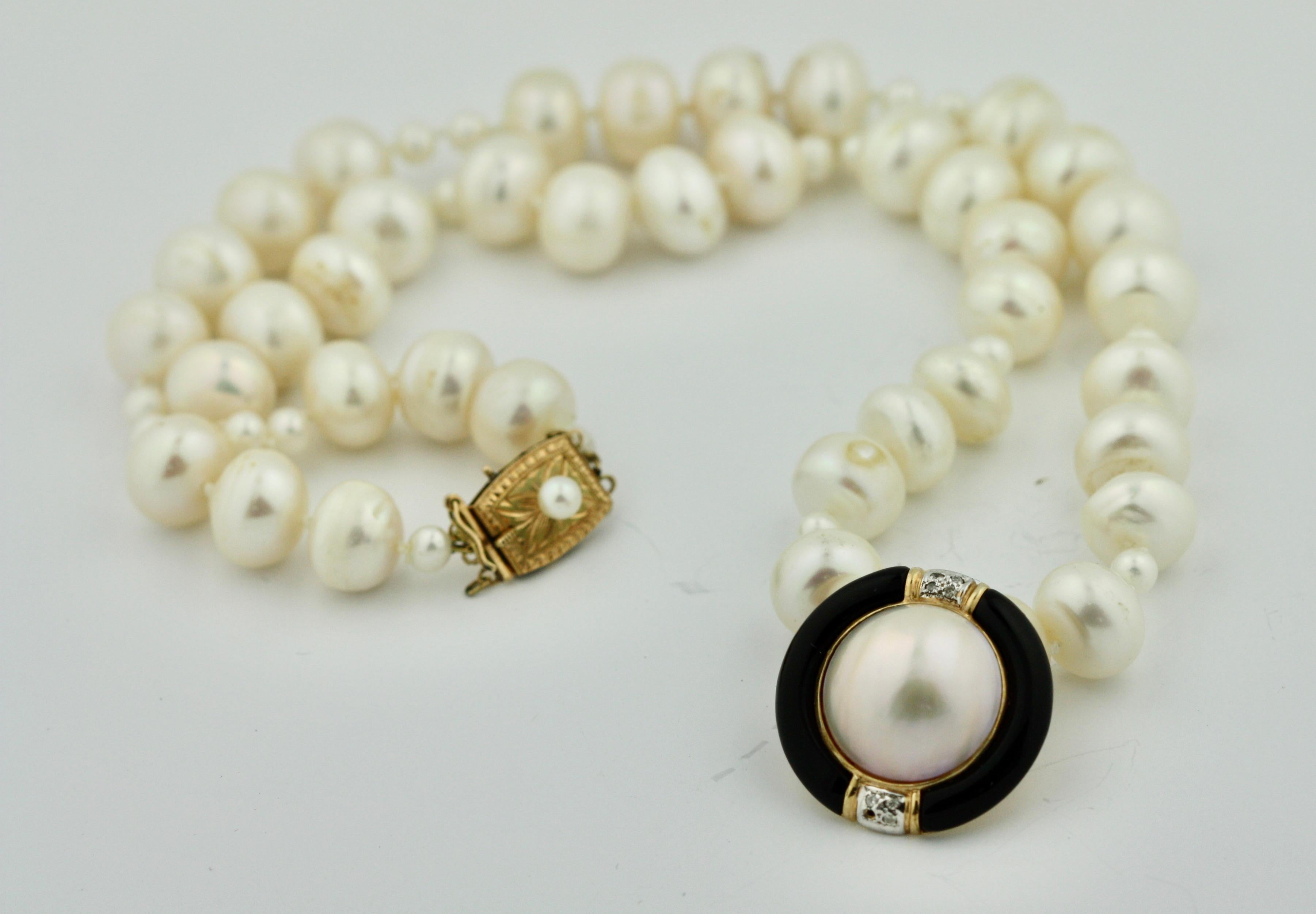 14 Karat Gold, Cultured Pearl, Mabé Pearl, Onyx and Diamond Necklace 
The single-strand composed of cultured pearls measuring approximately 4.2 to 10 mm., 
completed by a gold clasp set with a cultured pearl, length 18 inches.