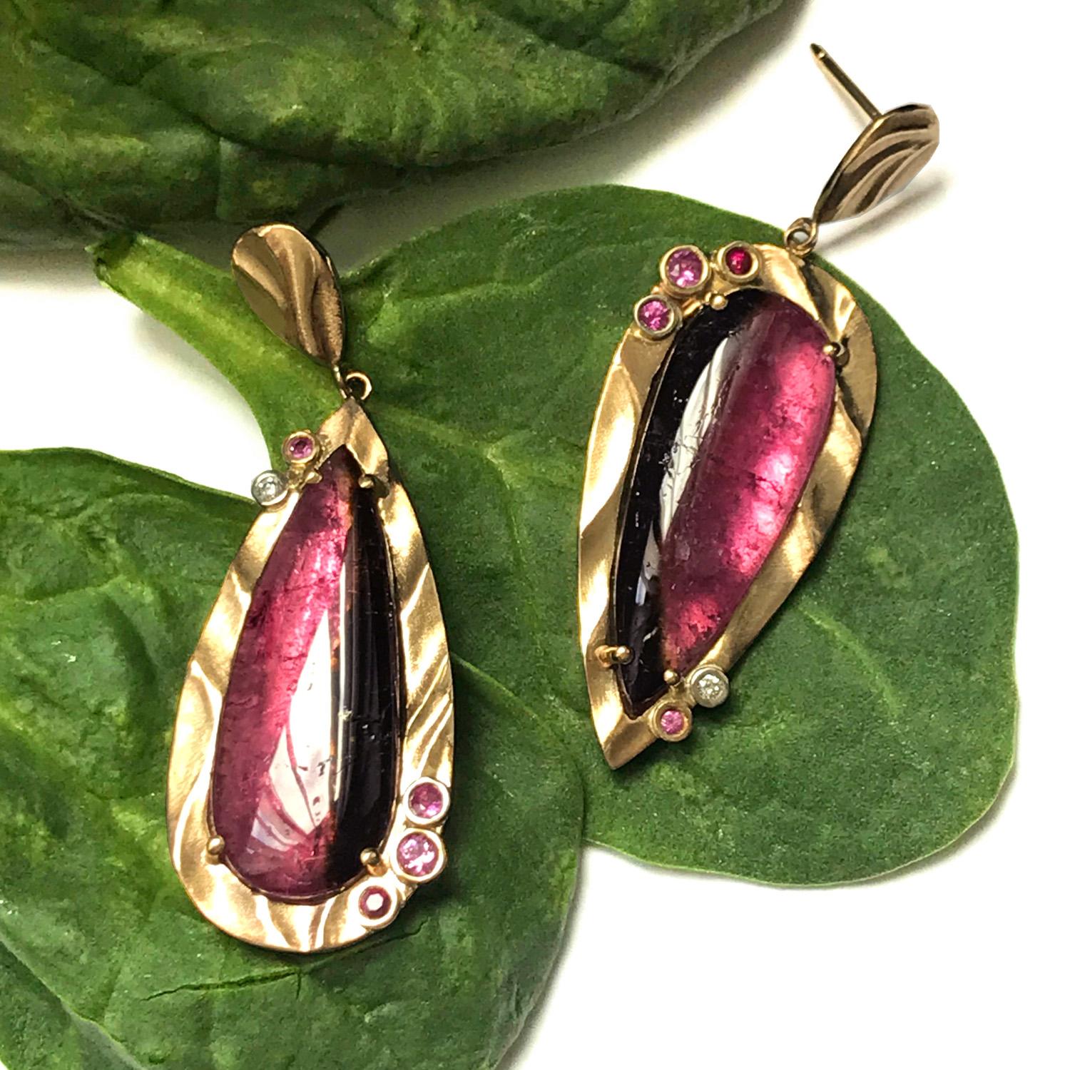 These mysterious Pink Mystique Earrings, which are 34mm long and 16mm at their widest point, feature unusual Bi-Color Pink Tourmalines (17.20ct total weight) accented with 0.29ct Pink Sapphire, 0.08ct Rubies and 0.03ct Diamonds. The 14 karat yellow