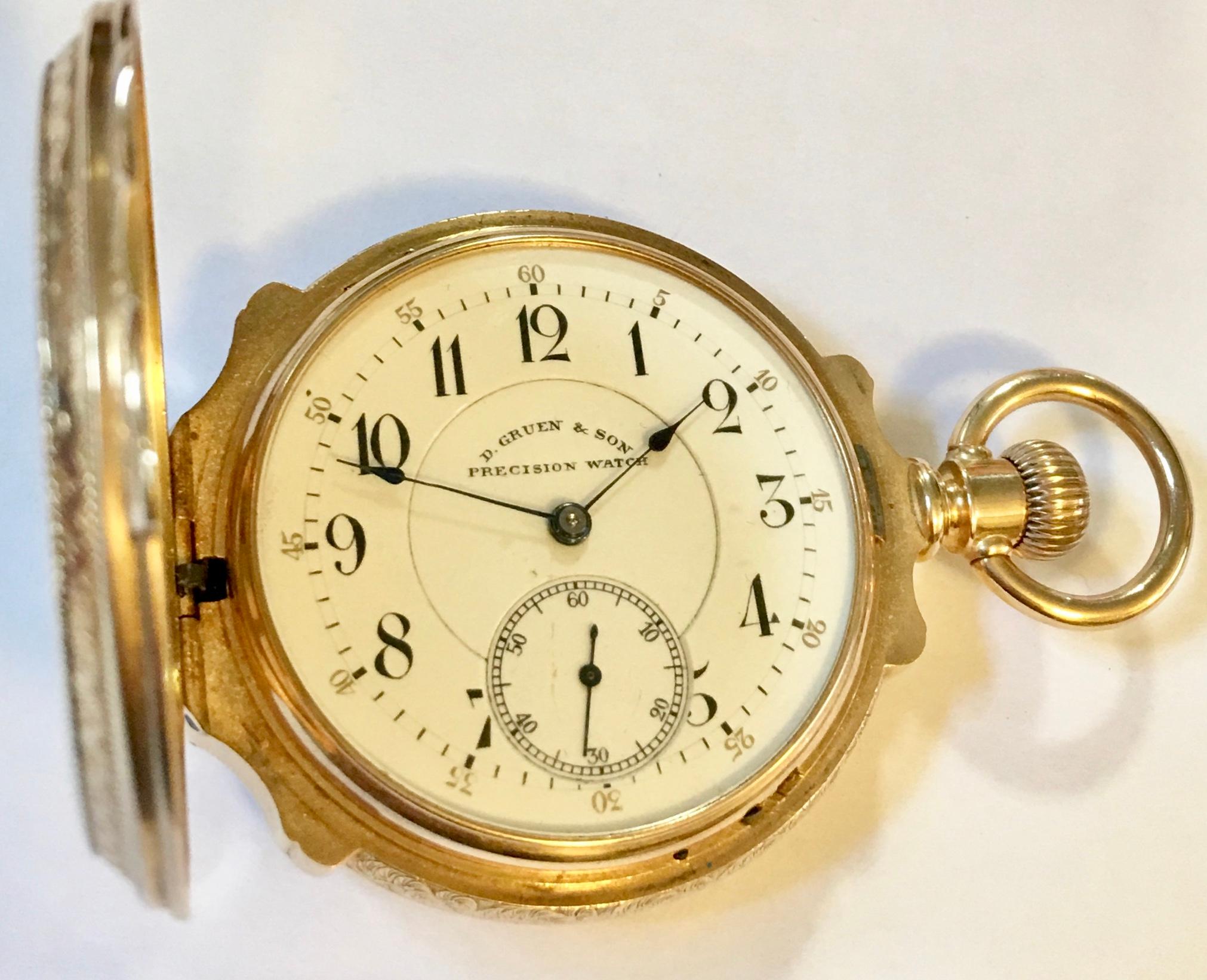 A 14-karat 53mm diameter gold solid full hunter pocket watch. The watch has a white enamel dial signed D.Gruen & Son with Arabic numerals and a subsidiary second hand dial. Also, has a smooth stem wind, a hinged back cover to protect its works and