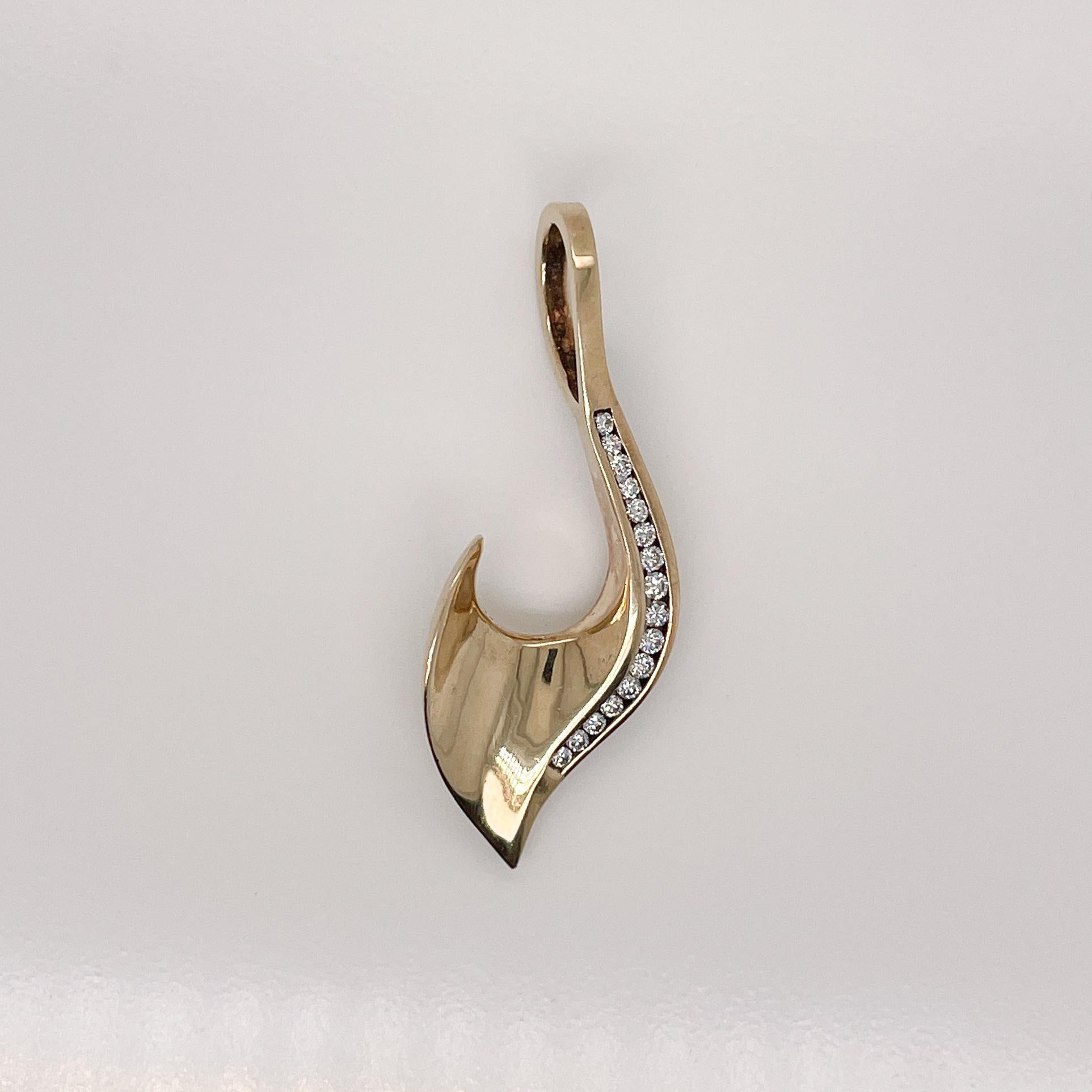 First Sentence: 
A very fine modernist gold and diamond pendant.

Comprised of a curved hook shape in 14k gold with channel set round brilliant diamonds. 

Simply an wonderful pendant!

(Chain for display purposes and not included with