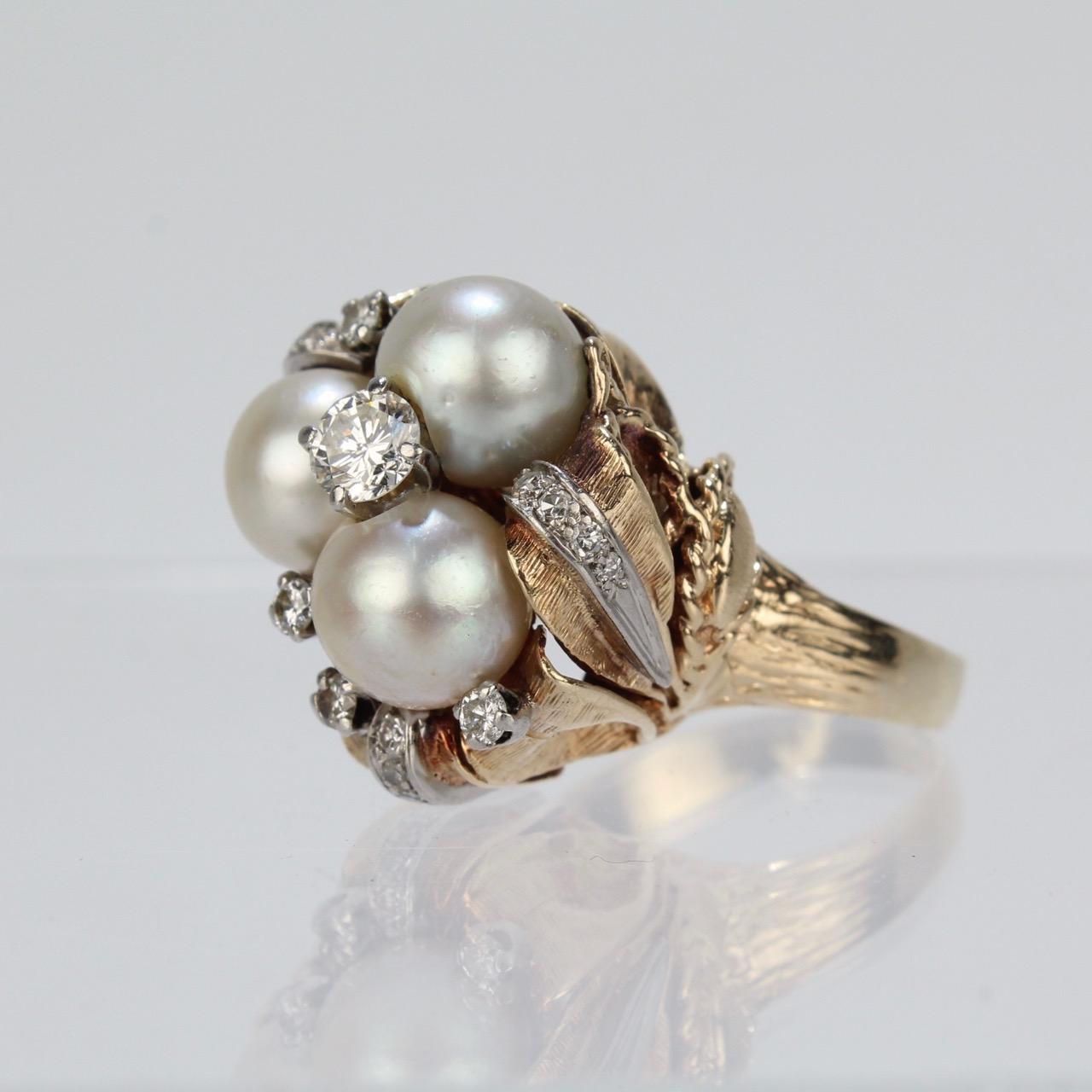 A large, elegant organic modern cocktail ring set with pearls and diamonds. 

Stylistically this ring brings together the impact of a classic, big cocktail ring with a very modernist (and even somewhat brutalist) spirit. 

The ring sits high on the